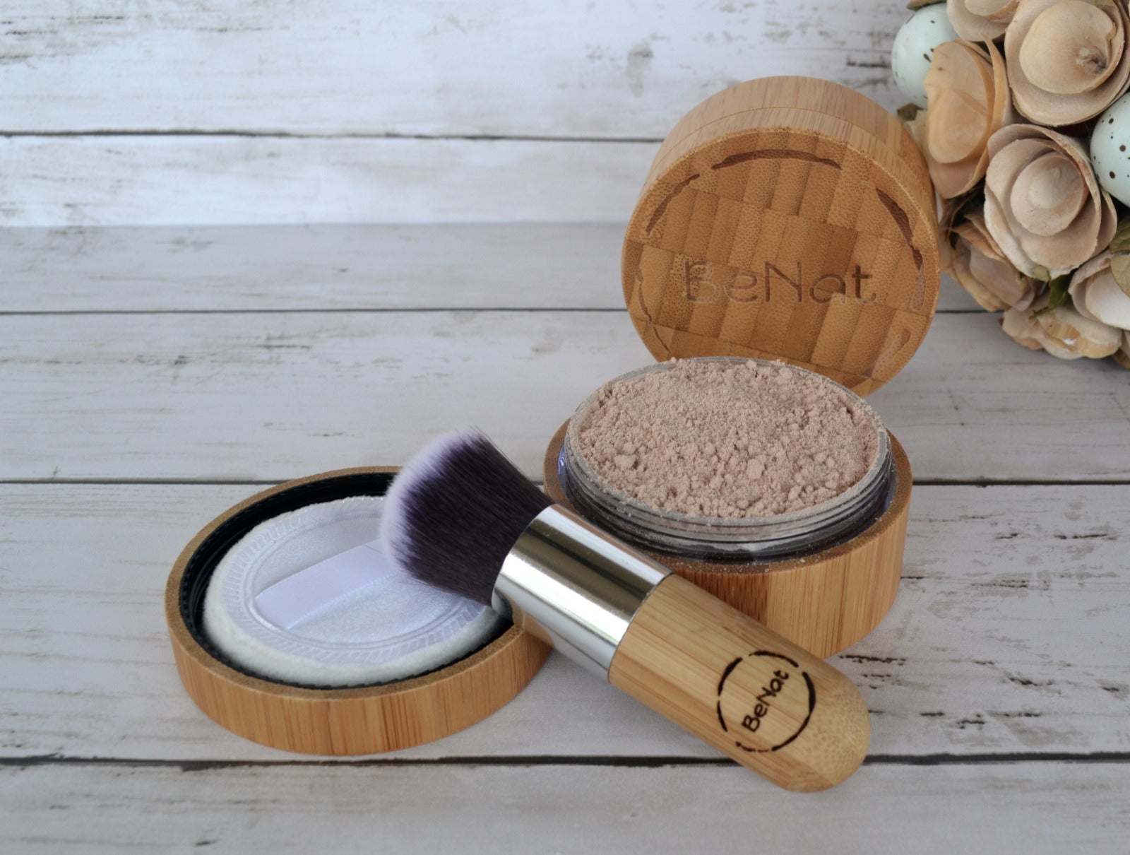 Translucent Loose Powder Set featuring a bamboo case, refill bag, and kabuki brush, showcasing eco-friendly beauty products.