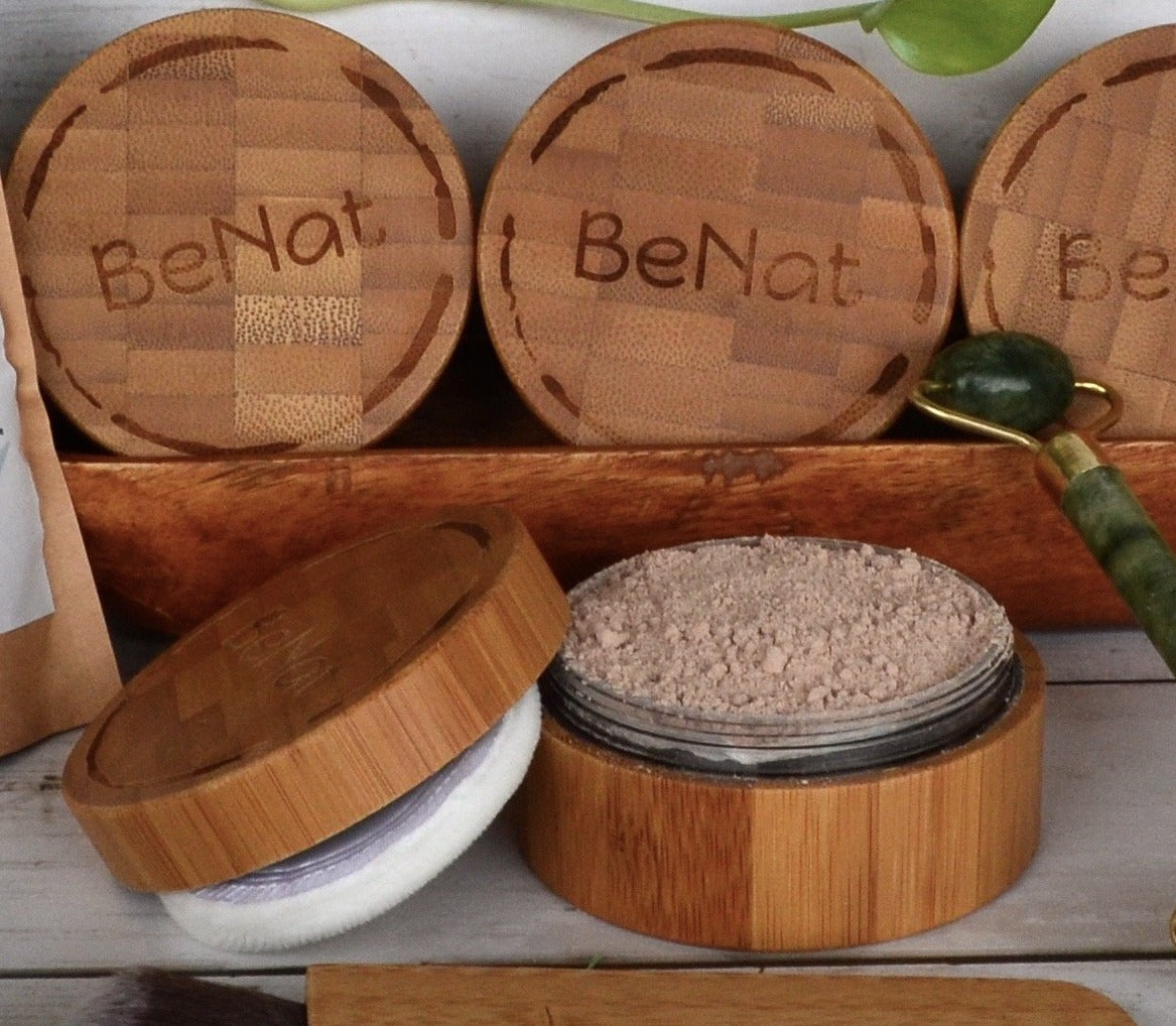 Translucent Loose Powder Set featuring a bamboo case, refill bag, and kabuki brush, showcasing eco-friendly beauty products.