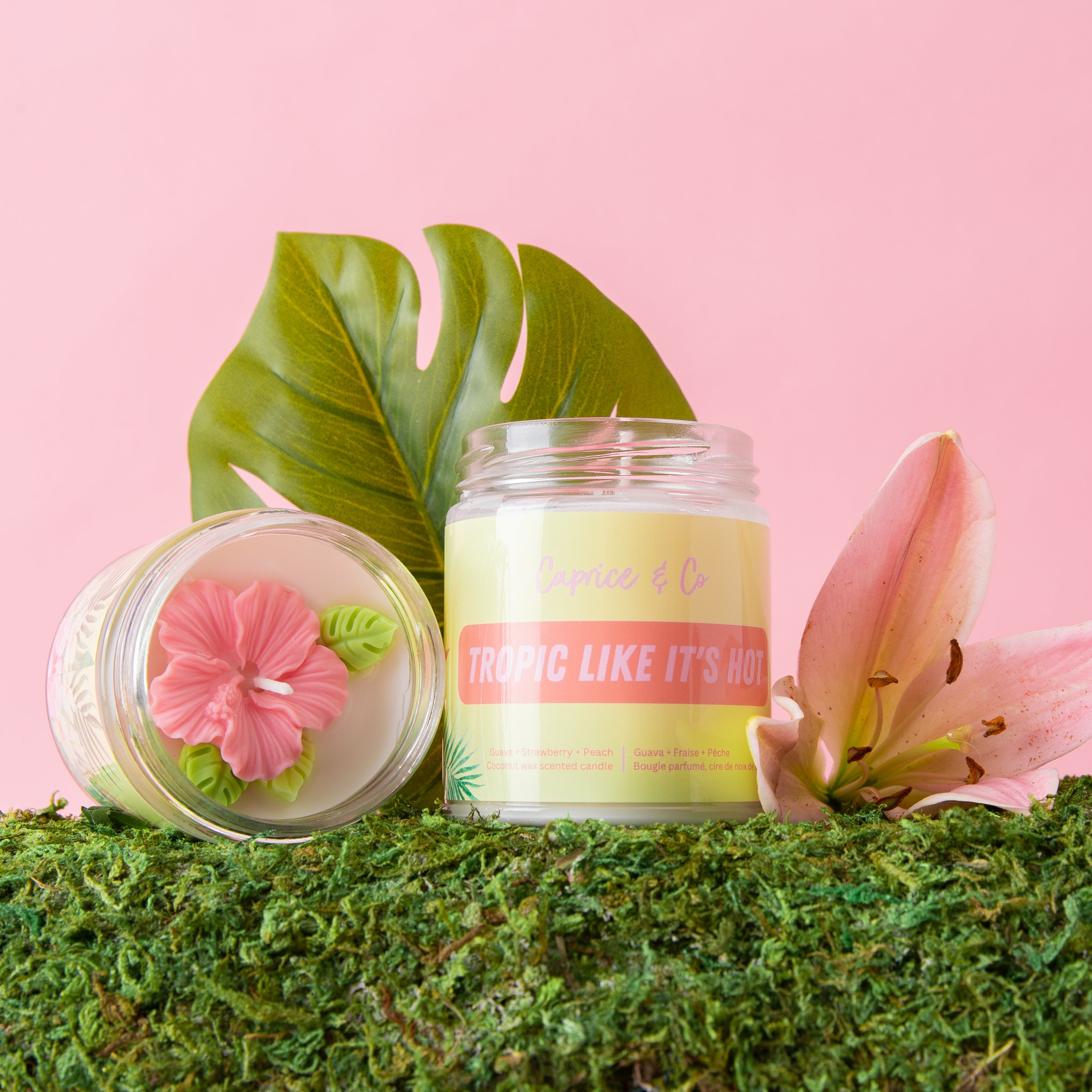 Tropic Like it's Hot Candle in a glass jar with a metal lid, featuring a tropical scent blend of guava, strawberry, and peach.