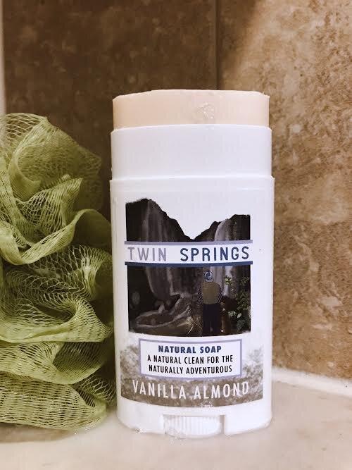 Twin Springs Vanilla Almond Soap Stick in a travel container, showcasing its handcrafted design and organic ingredients.