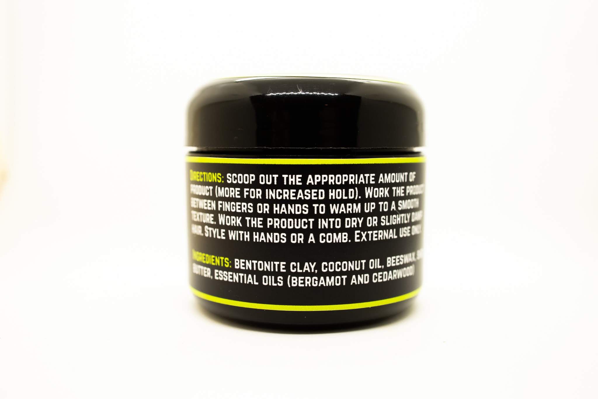 Vulcan Natural Hair Styling Clay in a stylish container, showcasing its natural ingredients and texture.