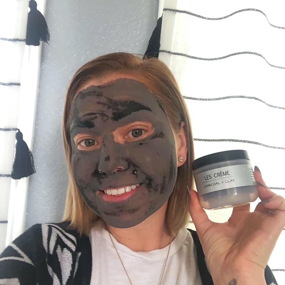 A jar of Weekly Detox Facial Mask with activated coconut charcoal and bentonite clay, showcasing its creamy texture and natural ingredients.