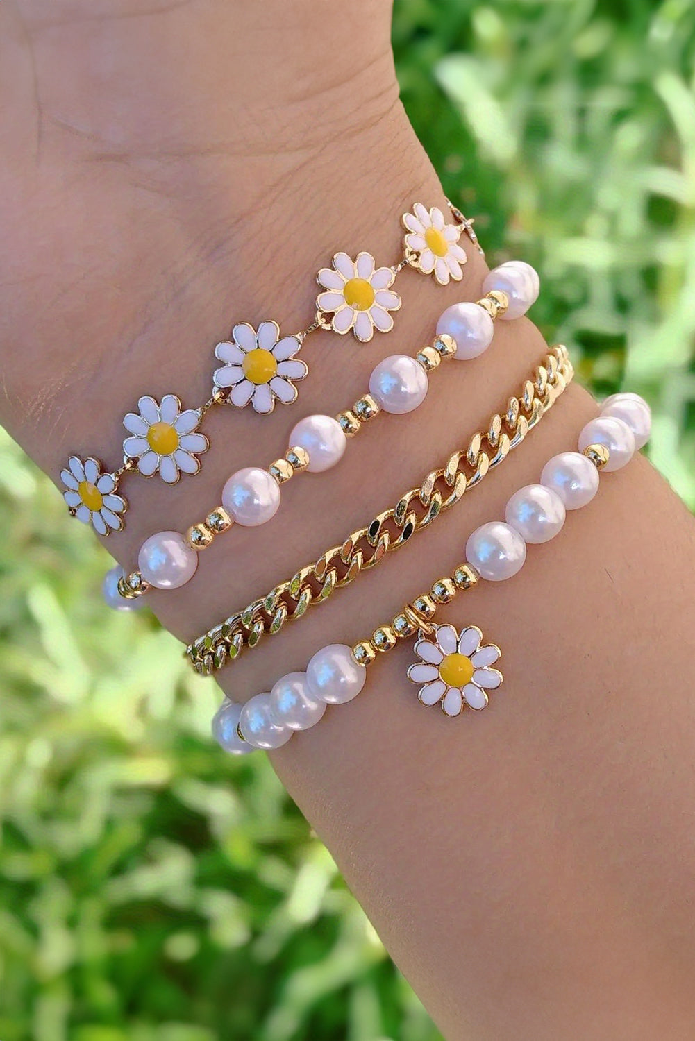 A beautiful set of four white daisy pearl beaded chain bracelets, showcasing elegant designs perfect for any occasion.