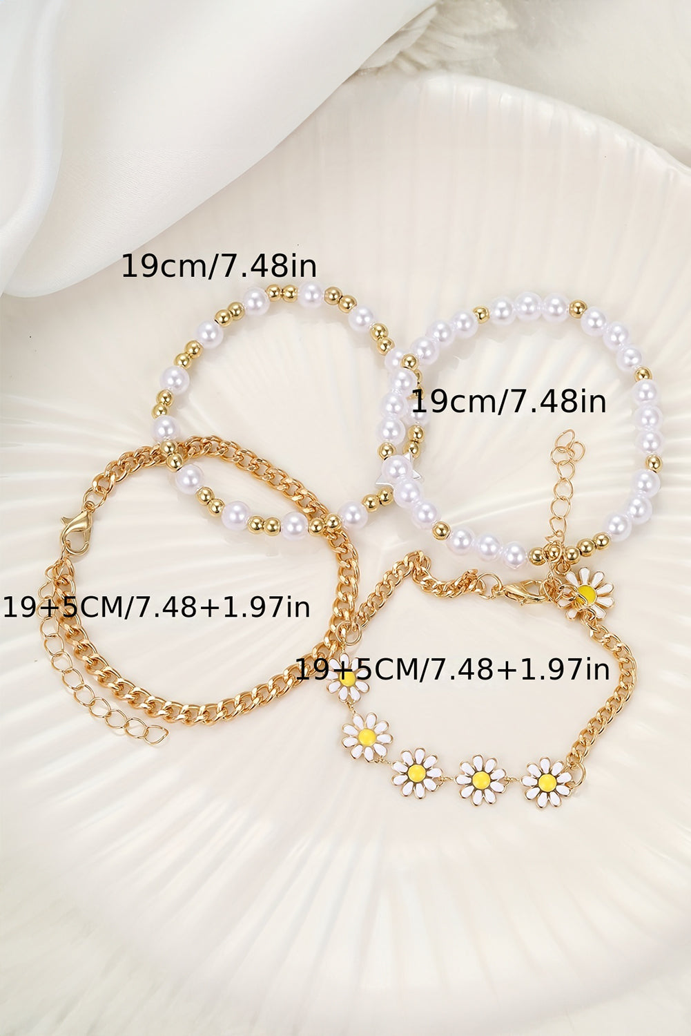 A beautiful set of four white daisy pearl beaded chain bracelets, showcasing elegant designs perfect for any occasion.