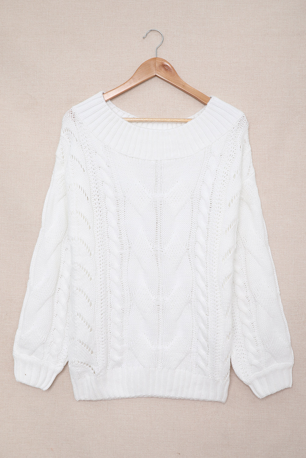 A cozy white chunky oversized pullover sweater with cable knit design, featuring a round neckline and ribbed cuffs, perfect for winter wear.