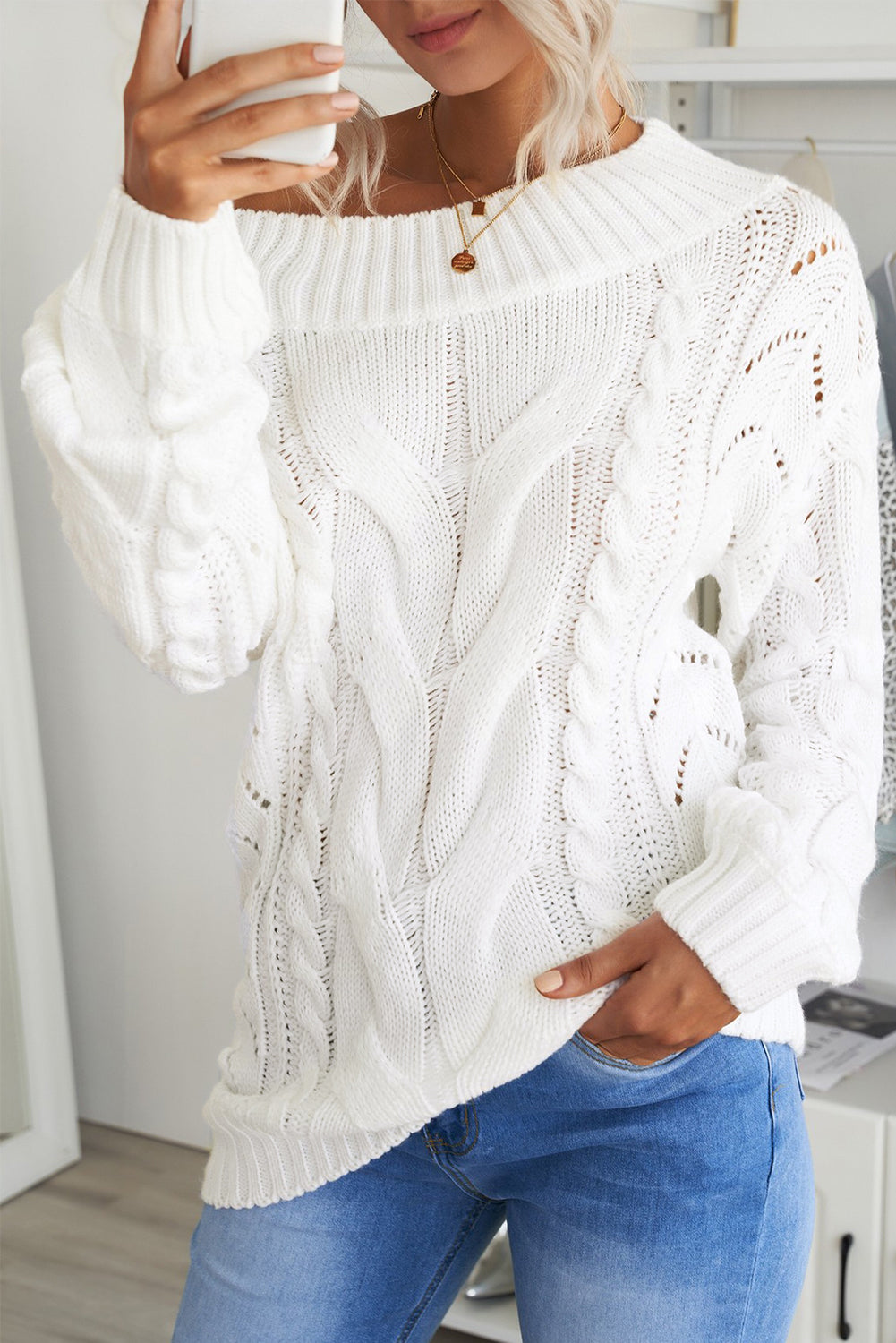 A cozy white chunky oversized pullover sweater with cable knit design, featuring a round neckline and ribbed cuffs, perfect for winter wear.