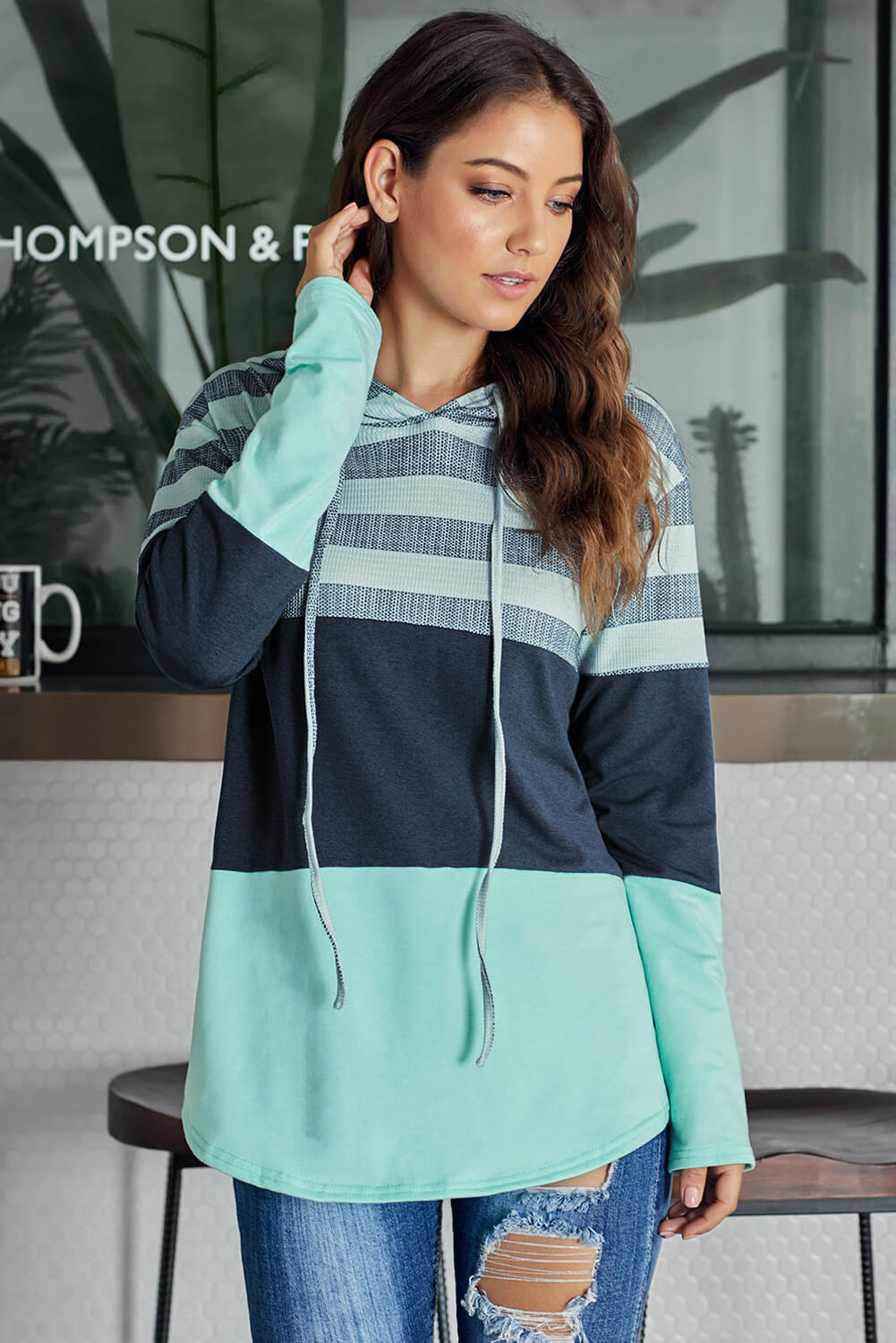 A stylish white color block drawstring hoodie featuring a classic pullover design with striped prints, perfect for casual wear.