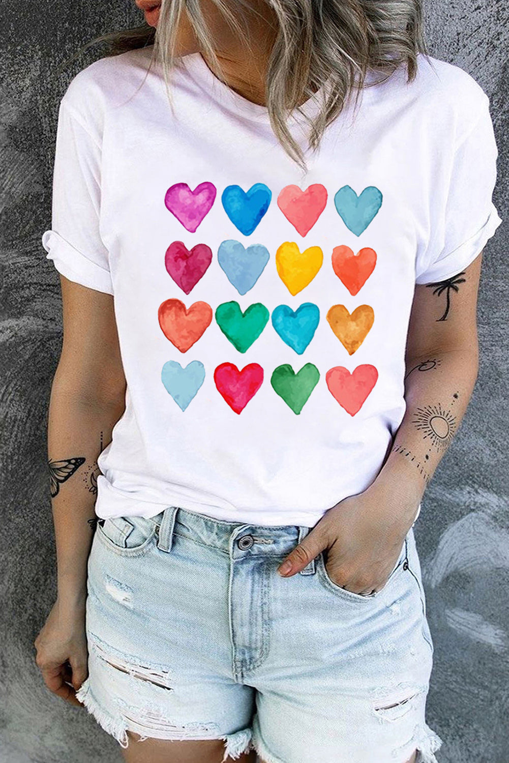 White crew neck T-shirt featuring colorful heart-shaped prints, perfect for summer and Valentine's Day.