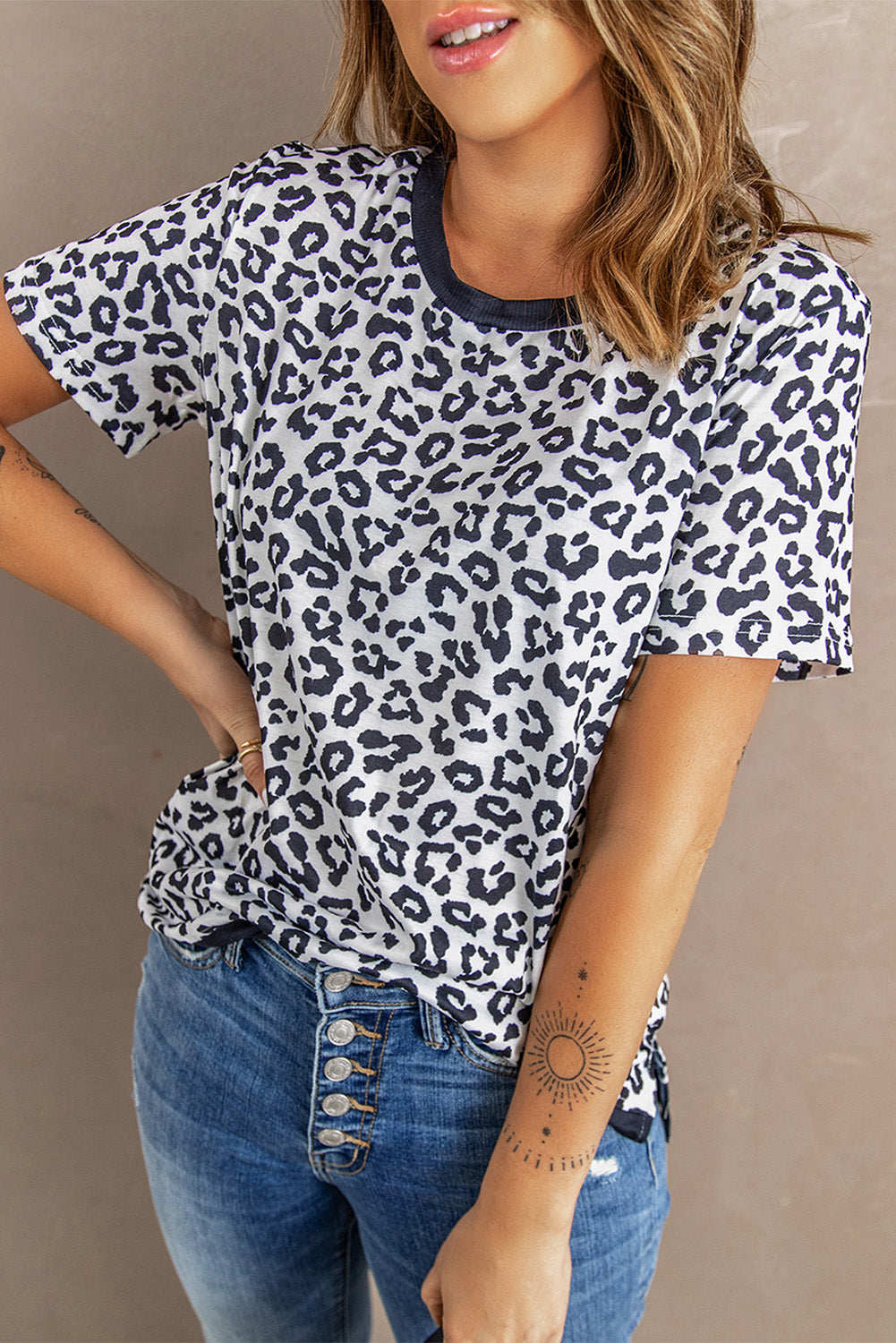 White Crew Neck T-shirt featuring a leopard print design on the sides and a stylish split, perfect for casual wear.