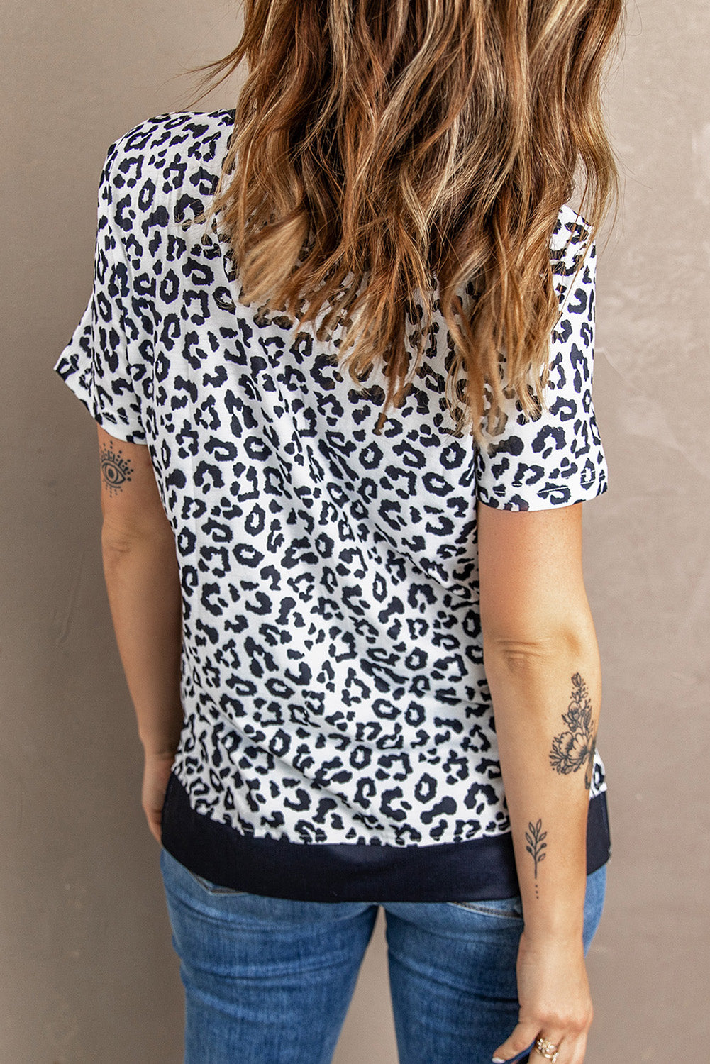 White Crew Neck T-shirt featuring a leopard print design on the sides and a stylish split, perfect for casual wear.