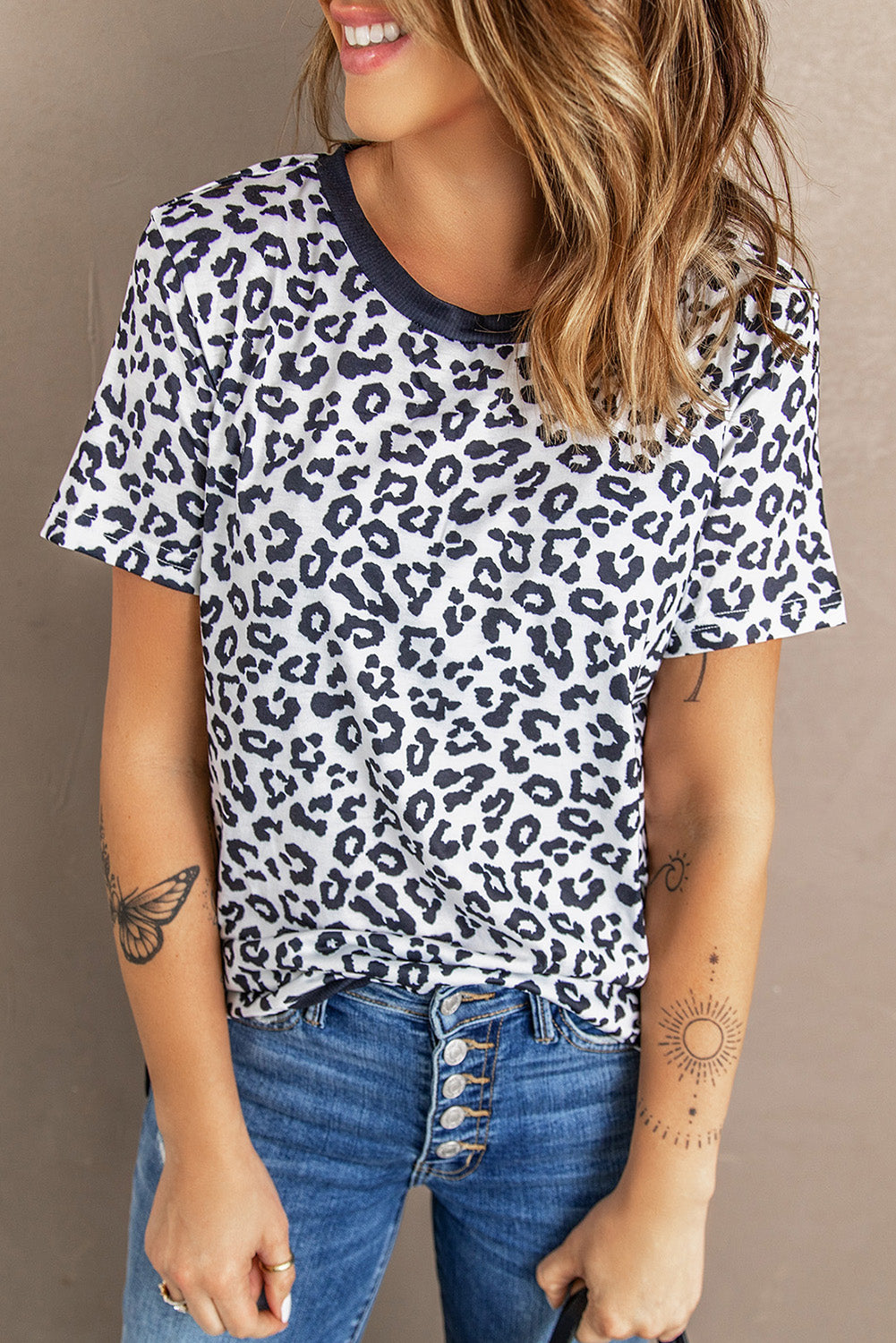 White Crew Neck T-shirt featuring a leopard print design on the sides and a stylish split, perfect for casual wear.