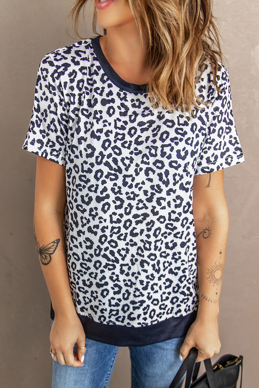 White Crew Neck T-shirt featuring a leopard print design on the sides and a stylish split, perfect for casual wear.