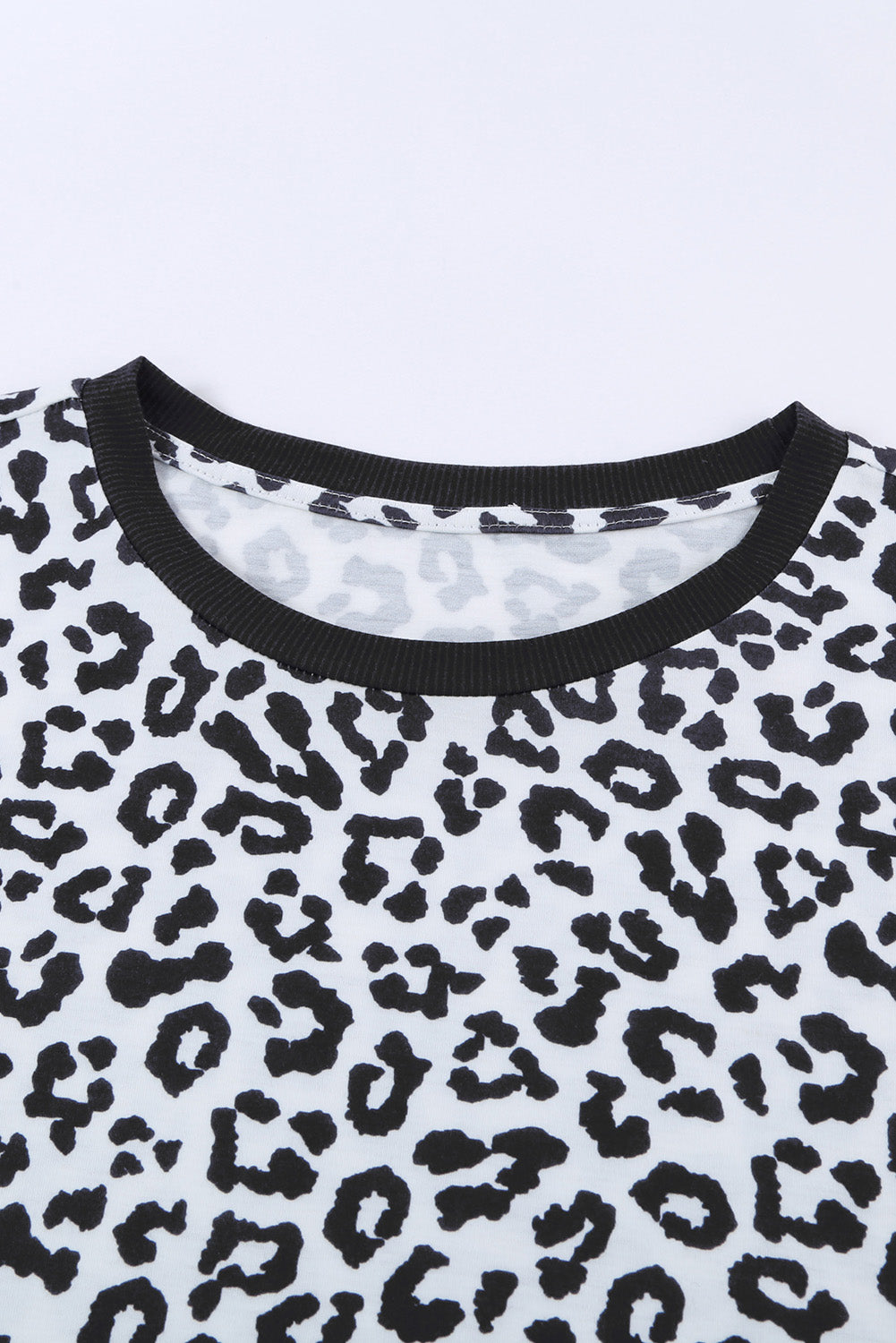 White Crew Neck T-shirt featuring a leopard print design on the sides and a stylish split, perfect for casual wear.