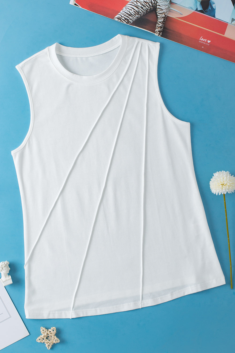 A stylish white crew neck pleated tank top displayed on a mannequin, showcasing its elegant design and pleated details.