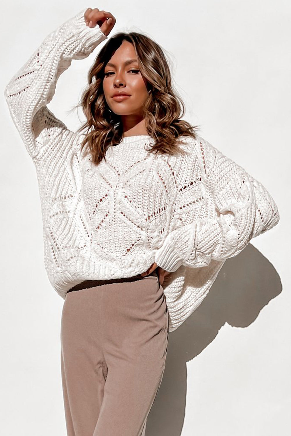 A stylish white crewneck sweater with balloon sleeves, featuring a textured knit design, perfect for casual wear.