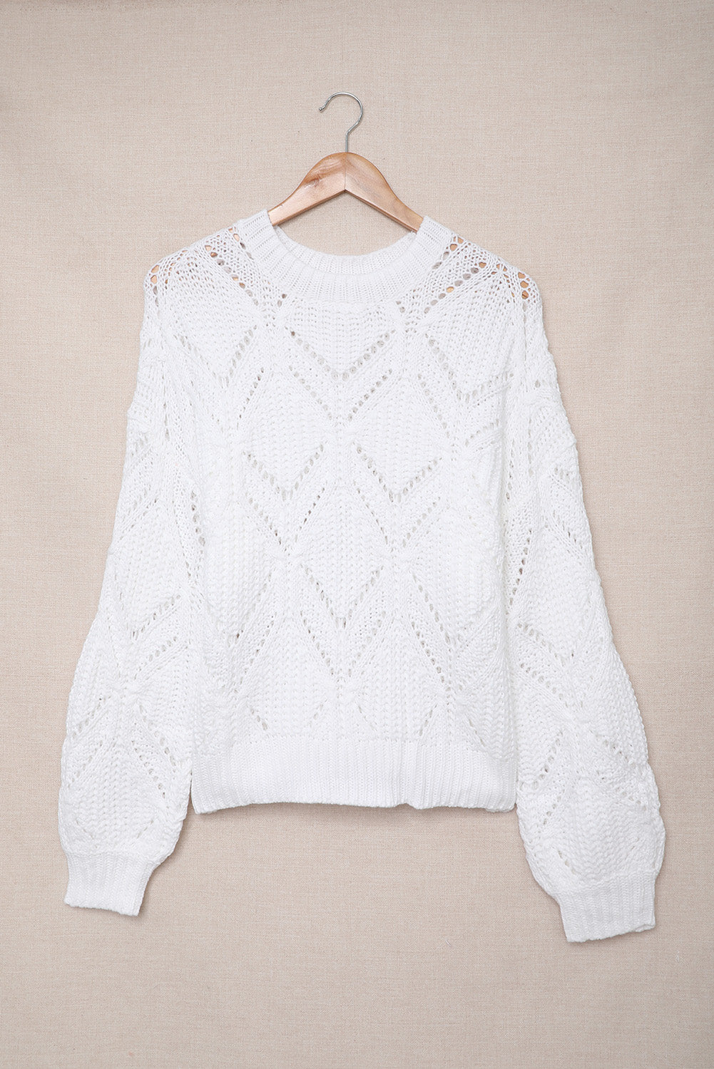 A stylish white crewneck sweater with balloon sleeves, featuring a textured knit design, perfect for casual wear.