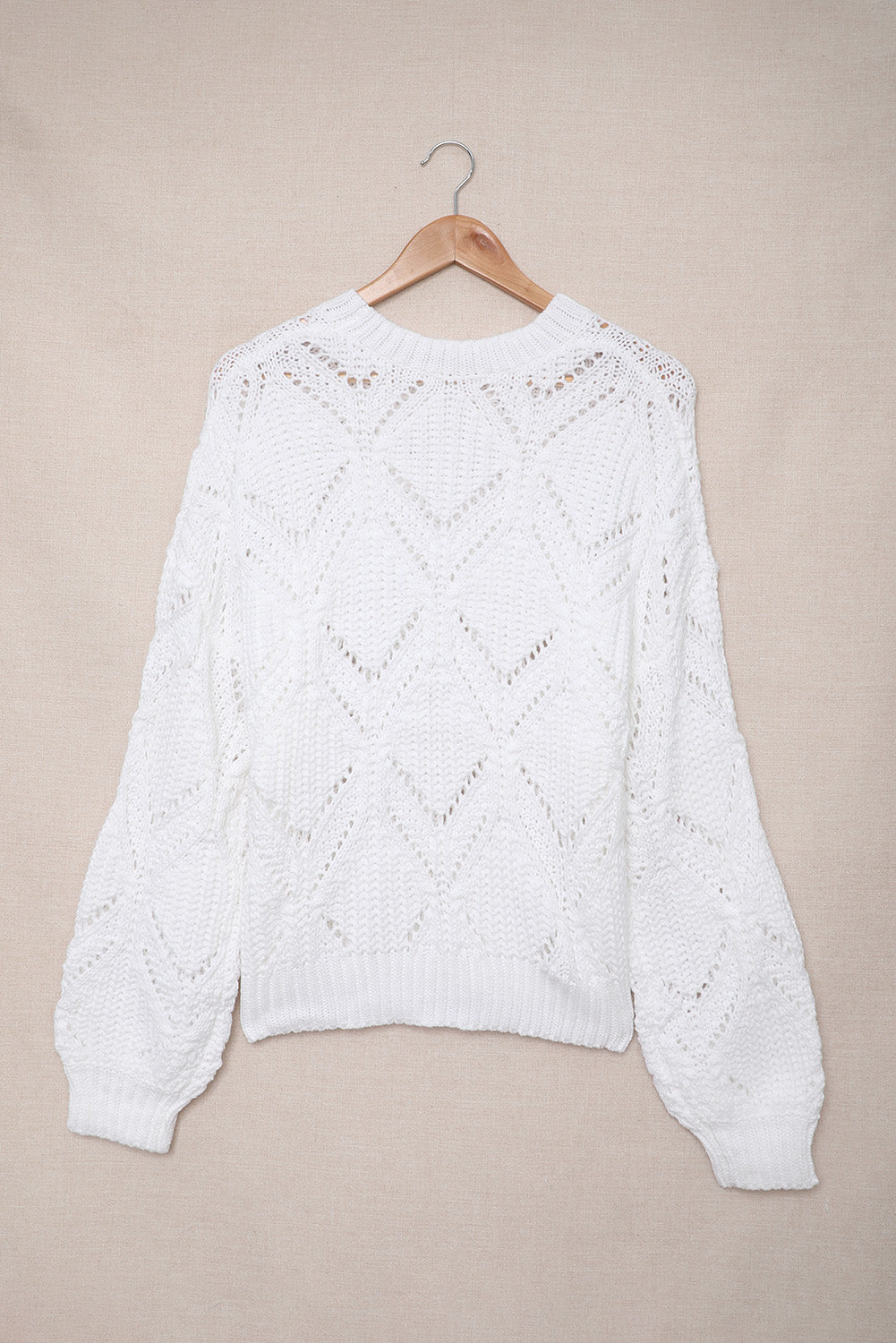 A stylish white crewneck sweater with balloon sleeves, featuring a textured knit design, perfect for casual wear.