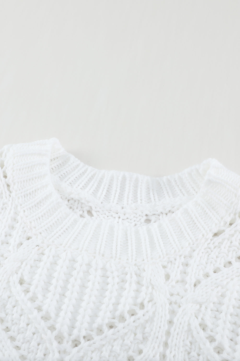 A stylish white crewneck sweater with balloon sleeves, featuring a textured knit design, perfect for casual wear.