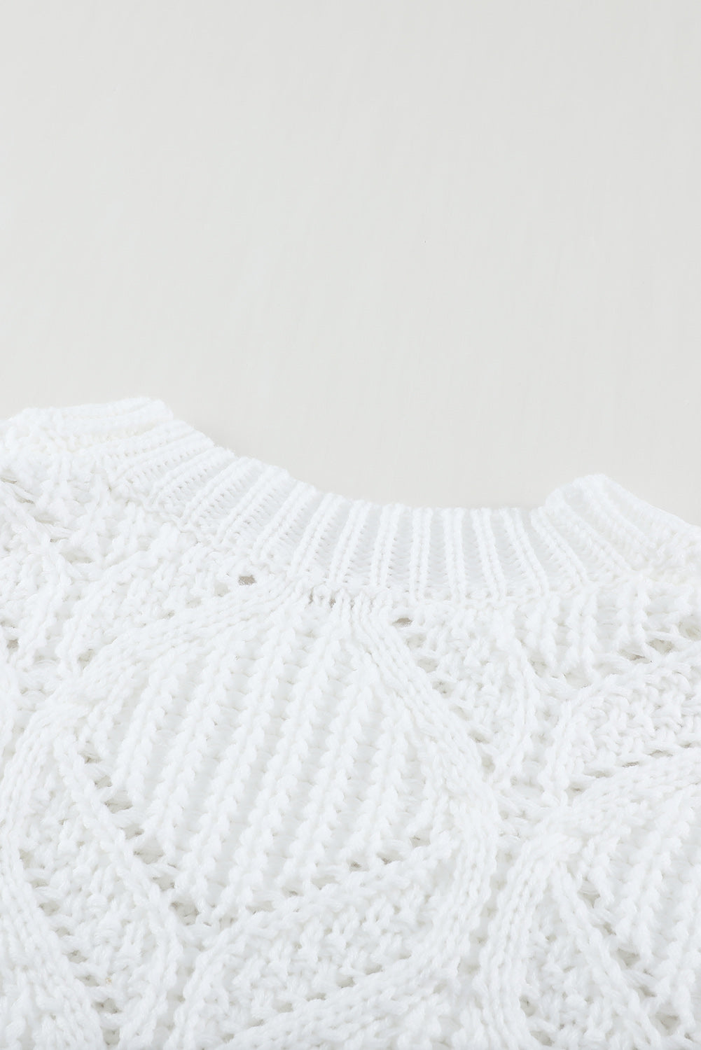 A stylish white crewneck sweater with balloon sleeves, featuring a textured knit design, perfect for casual wear.