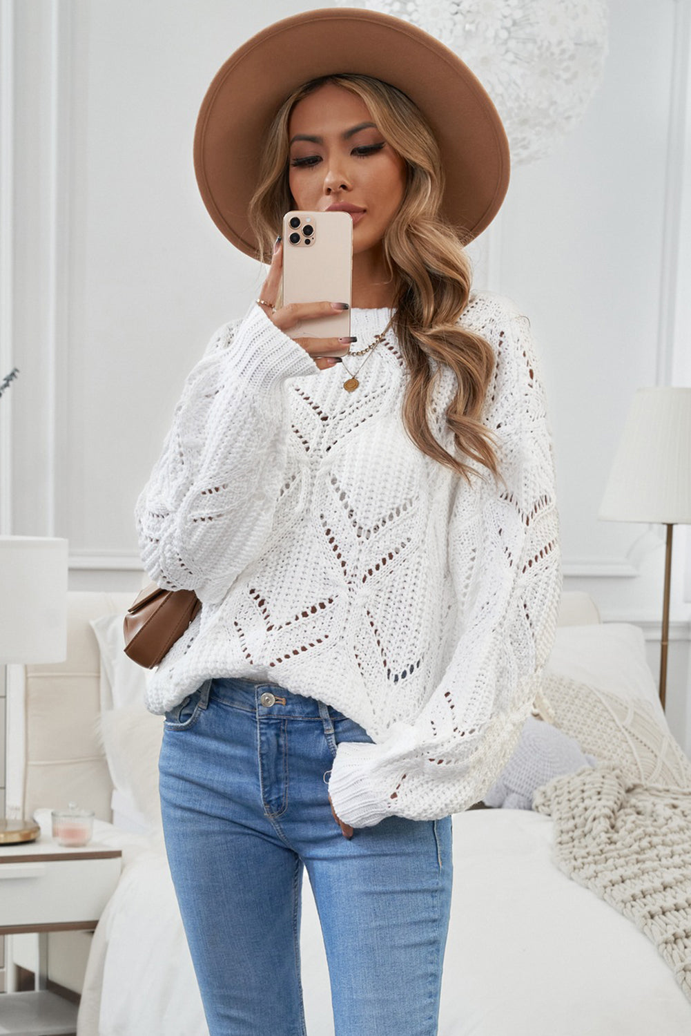 A stylish white crewneck sweater with balloon sleeves, featuring a textured knit design, perfect for casual wear.