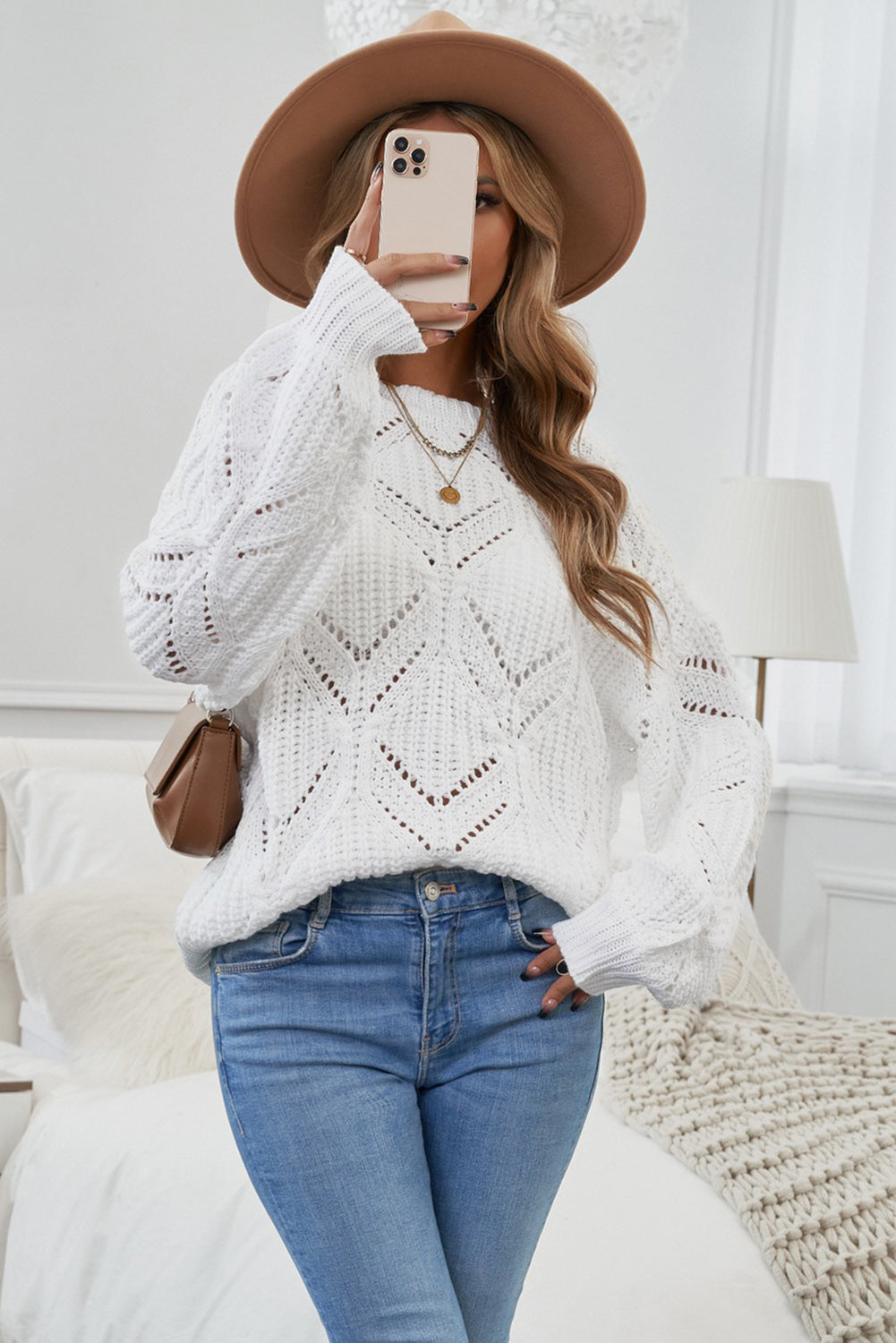 A stylish white crewneck sweater with balloon sleeves, featuring a textured knit design, perfect for casual wear.