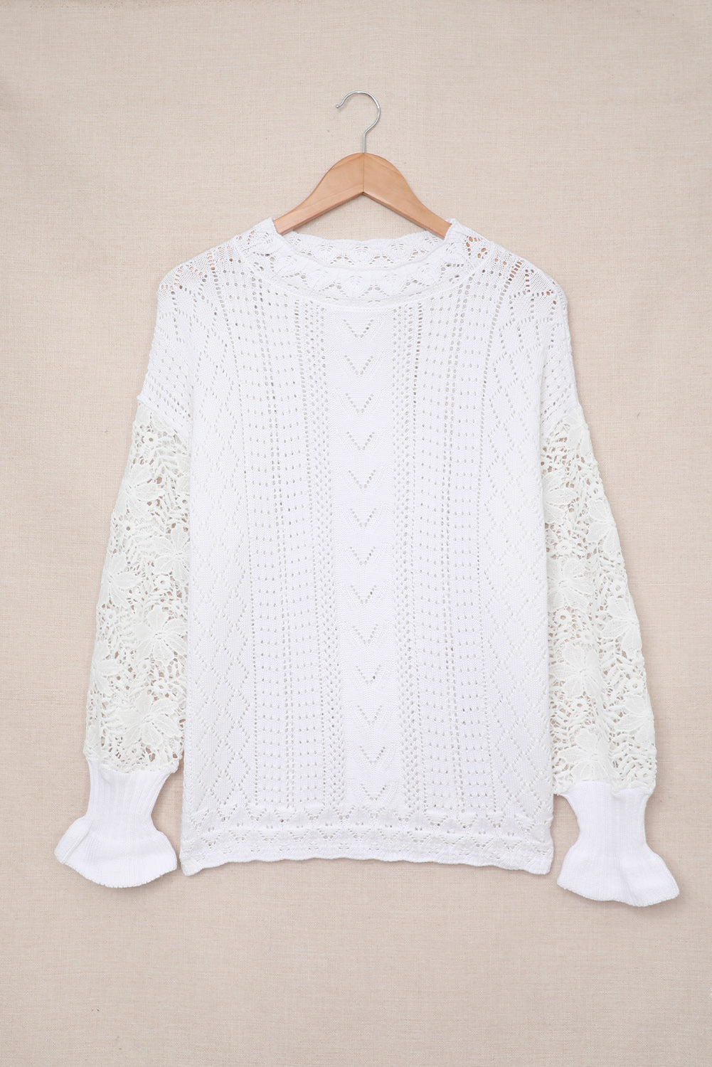 A stylish white crochet lace pointelle knit sweater featuring a scalloped neckline and sheer lace sleeves, perfect for casual and chic outfits.