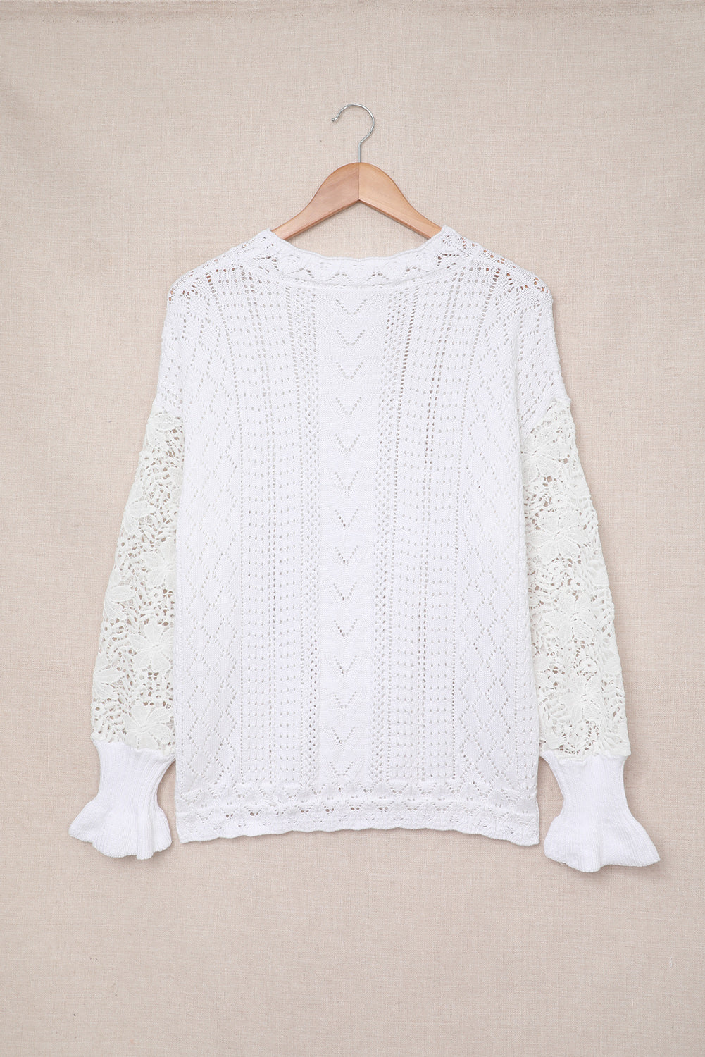 A stylish white crochet lace pointelle knit sweater featuring a scalloped neckline and sheer lace sleeves, perfect for casual and chic outfits.