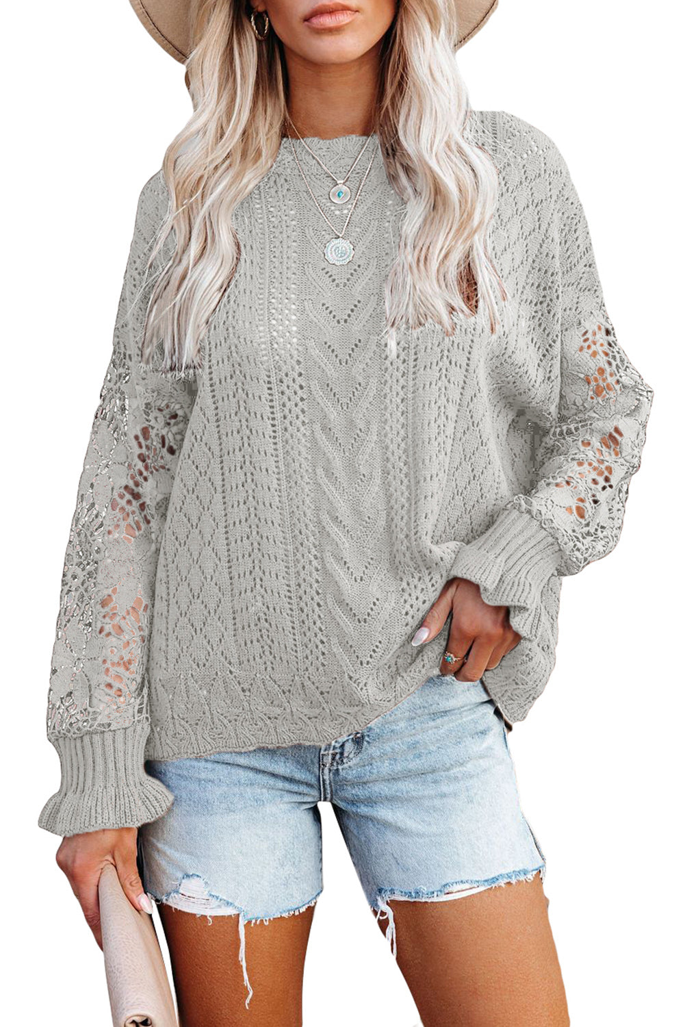 A stylish white crochet lace pointelle knit sweater featuring a scalloped neckline and sheer lace sleeves, perfect for casual and chic outfits.