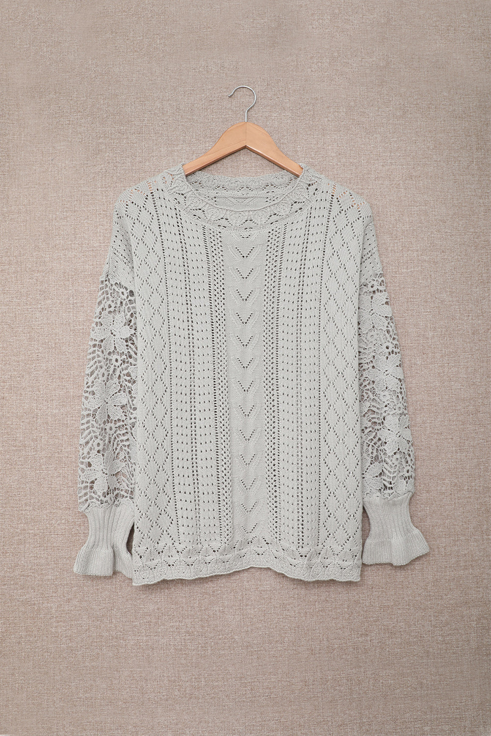 A stylish white crochet lace pointelle knit sweater featuring a scalloped neckline and sheer lace sleeves, perfect for casual and chic outfits.