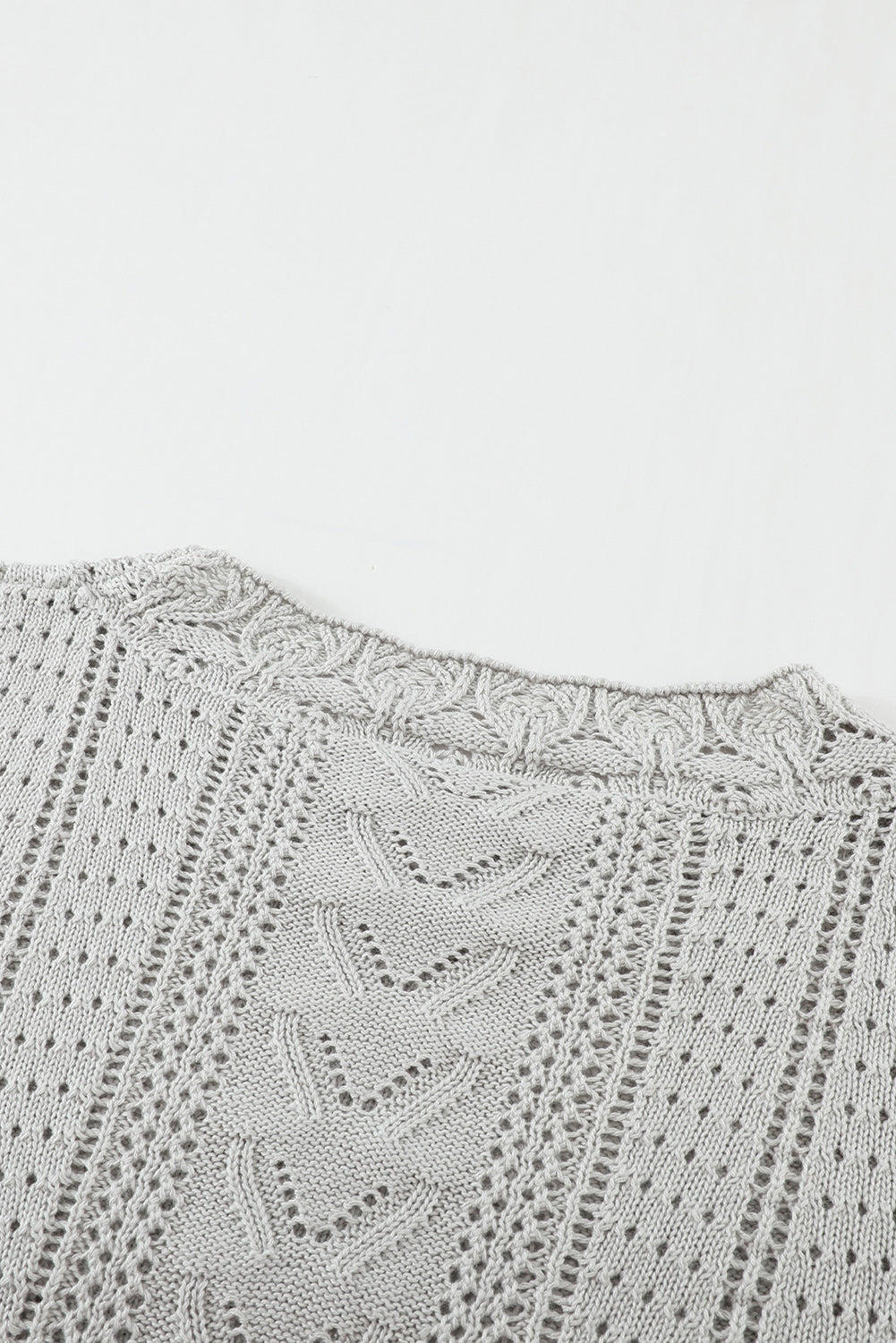 A stylish white crochet lace pointelle knit sweater featuring a scalloped neckline and sheer lace sleeves, perfect for casual and chic outfits.