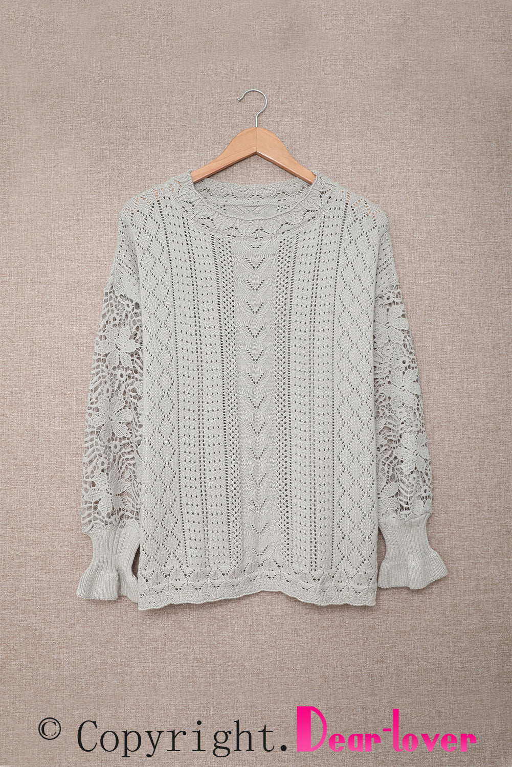 A stylish white crochet lace pointelle knit sweater featuring a scalloped neckline and sheer lace sleeves, perfect for casual and chic outfits.