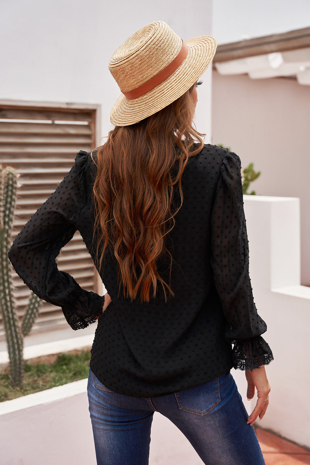 A stylish white blouse featuring a v-neck design, swiss dot pattern, and lace trim on the neckline and sleeves, perfect for casual or formal wear.