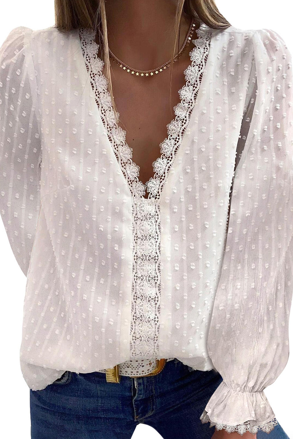 A stylish white blouse featuring a v-neck design, swiss dot pattern, and lace trim on the neckline and sleeves, perfect for casual or formal wear.