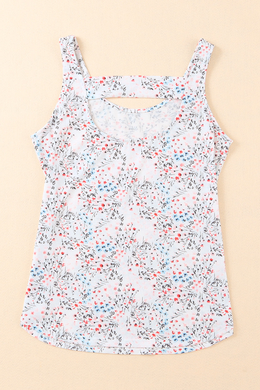 A stylish white tank top featuring a floral print and a cut-out back design, perfect for casual wear.