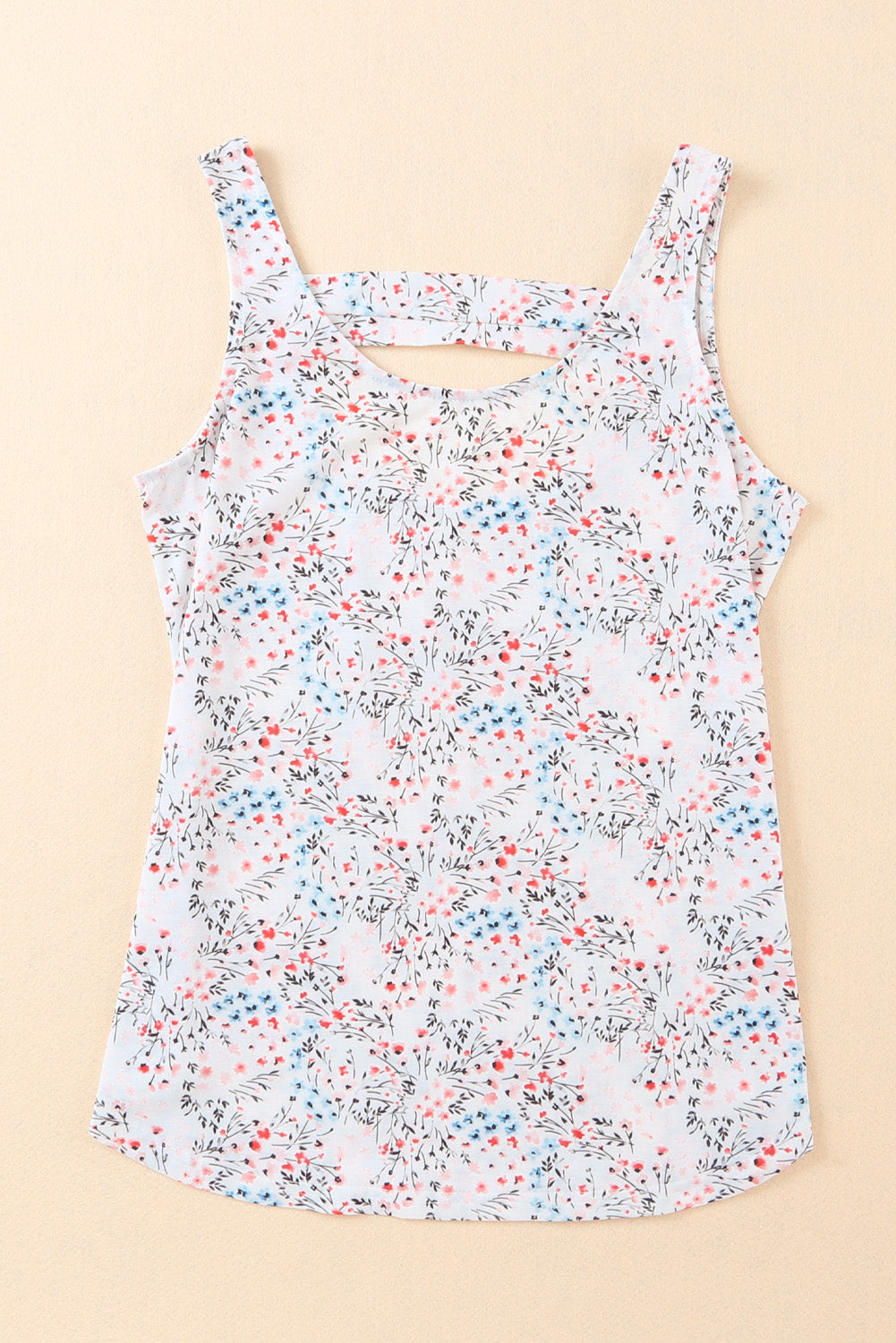 A stylish white tank top featuring a floral print and a cut-out back design, perfect for casual wear.