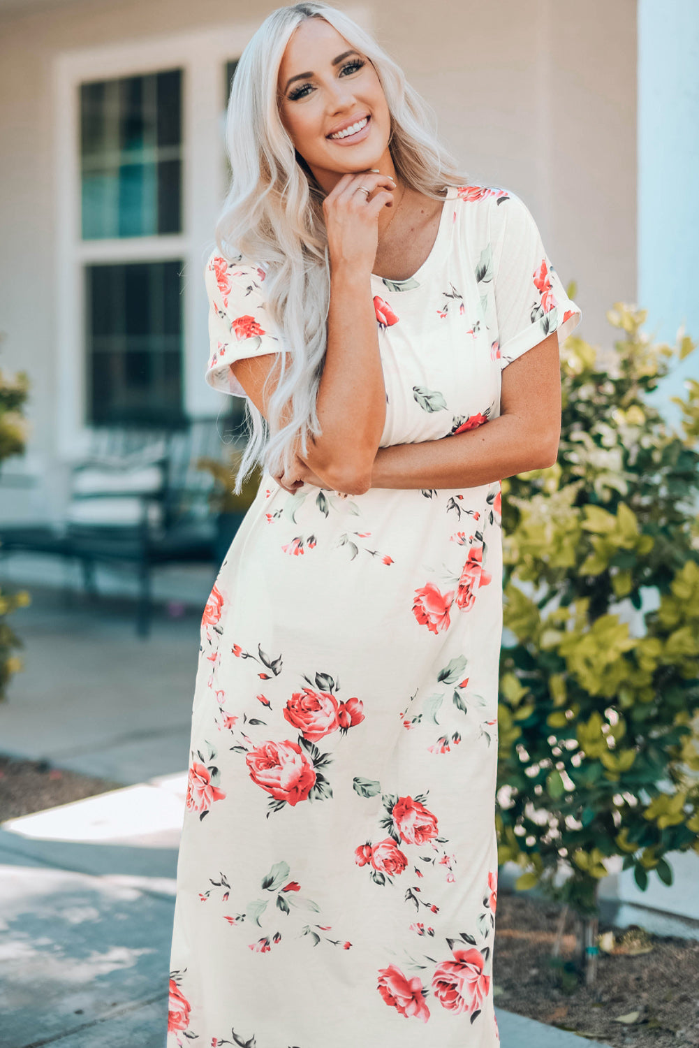 A stylish white t shirt dress featuring a vibrant floral print, side slits, and short sleeves, perfect for summer outings.