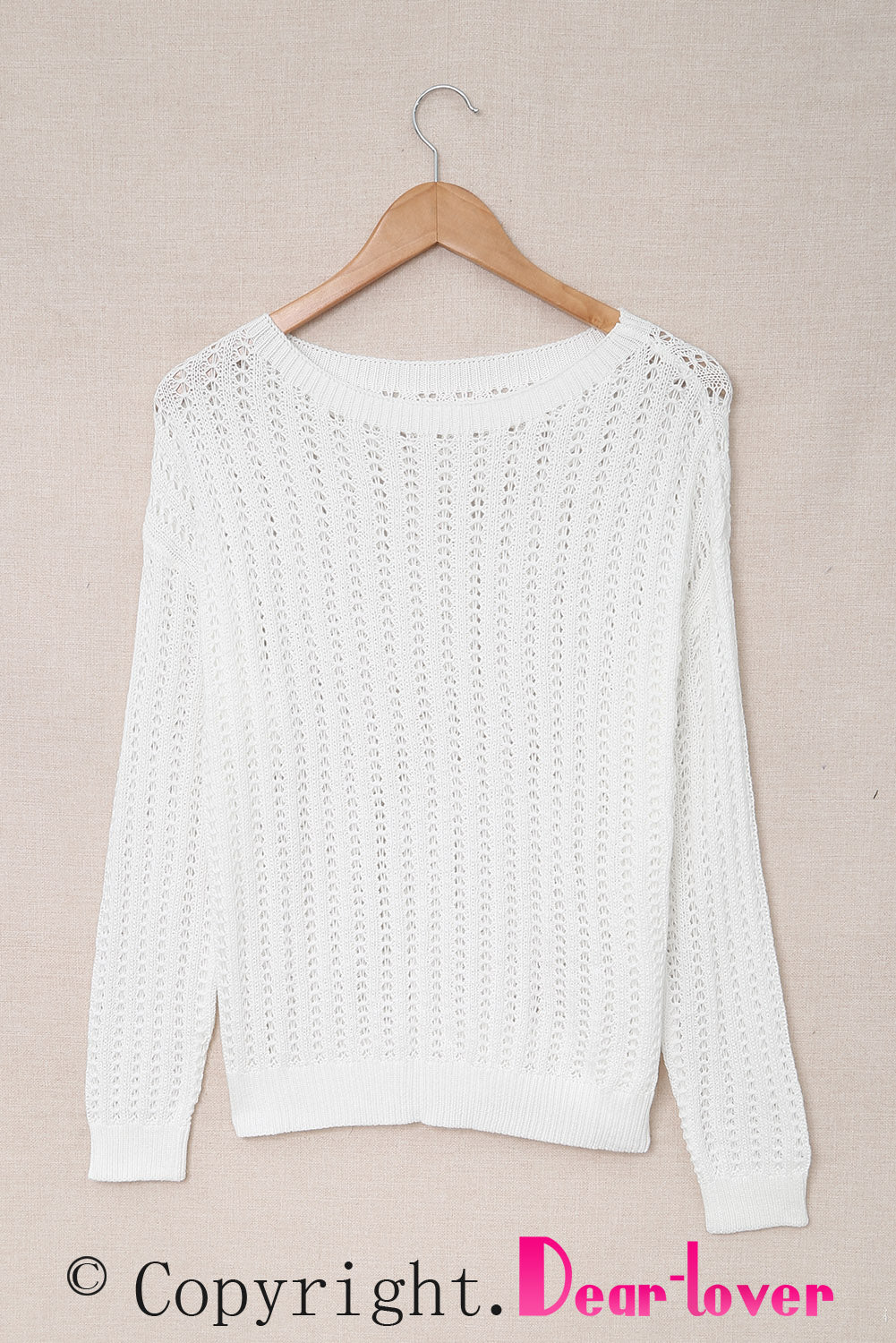 A stylish white knitted sweater featuring a hollow-out design and drop shoulder style, perfect for a chic and relaxed look.