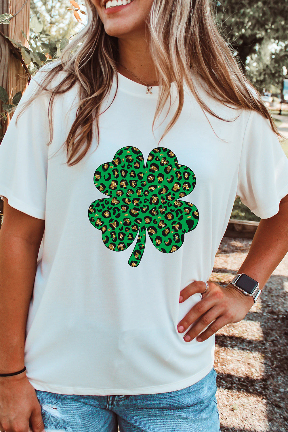 White Leopard Four Leaf Clover Graphic Tee featuring a stylish leopard print and four-leaf clover design.