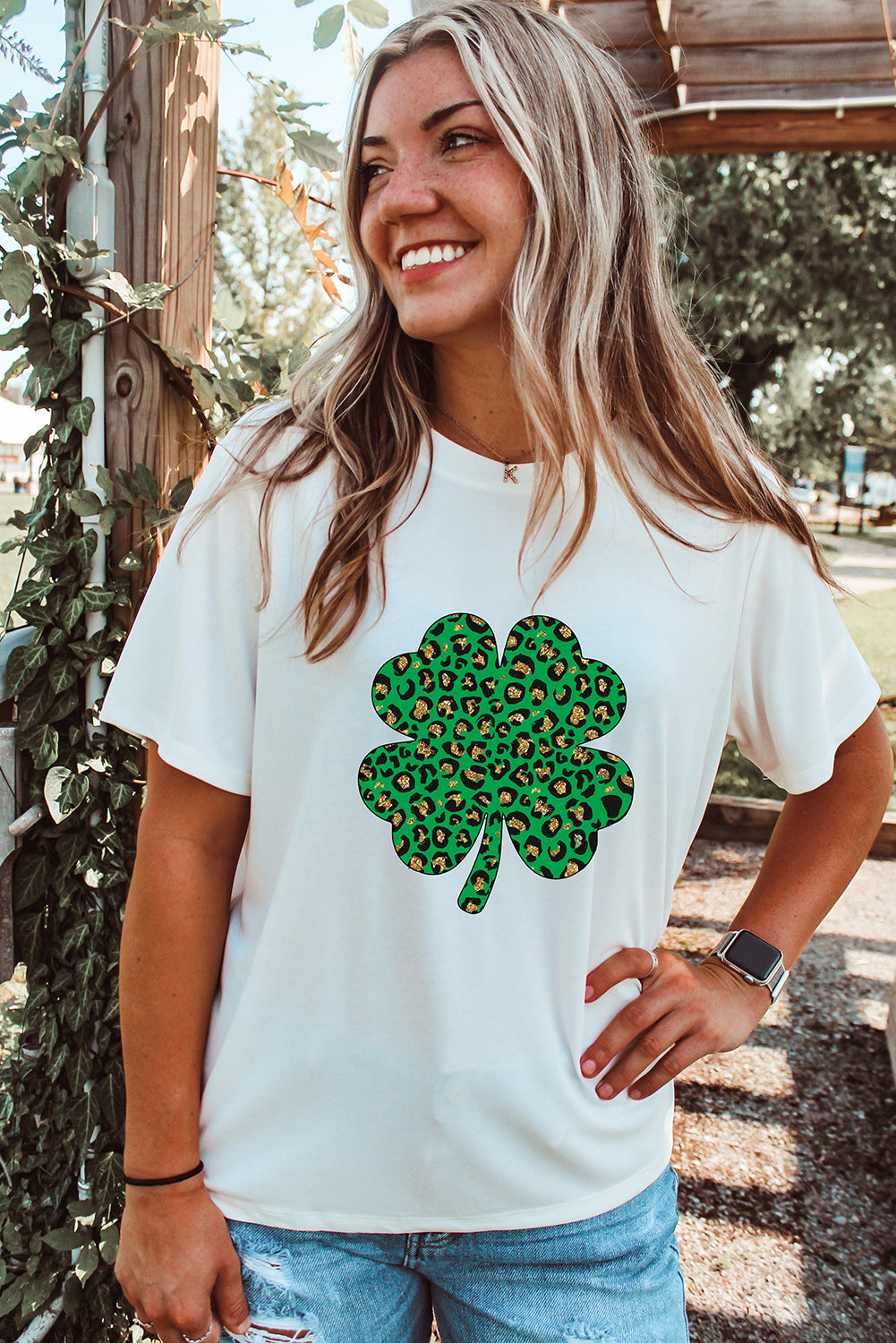 White Leopard Four Leaf Clover Graphic Tee featuring a stylish leopard print and four-leaf clover design.