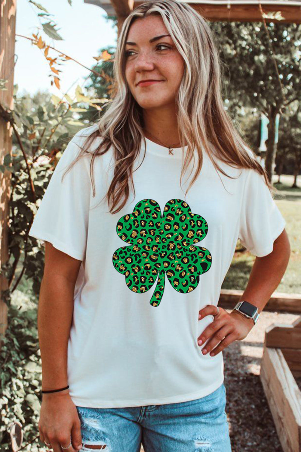 White Leopard Four Leaf Clover Graphic Tee featuring a stylish leopard print and four-leaf clover design.