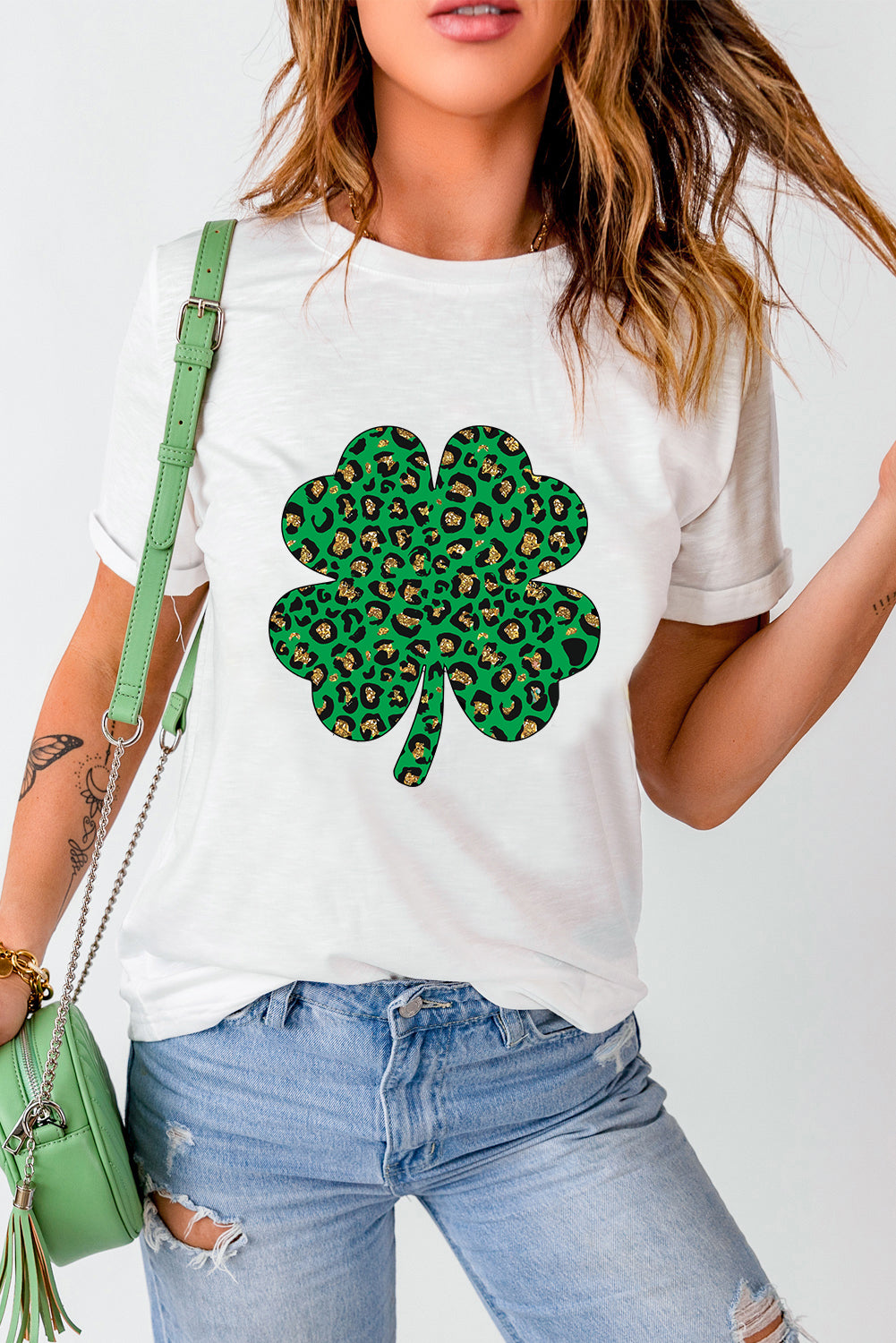 White Leopard Four Leaf Clover Graphic Tee featuring a stylish leopard print and four-leaf clover design.