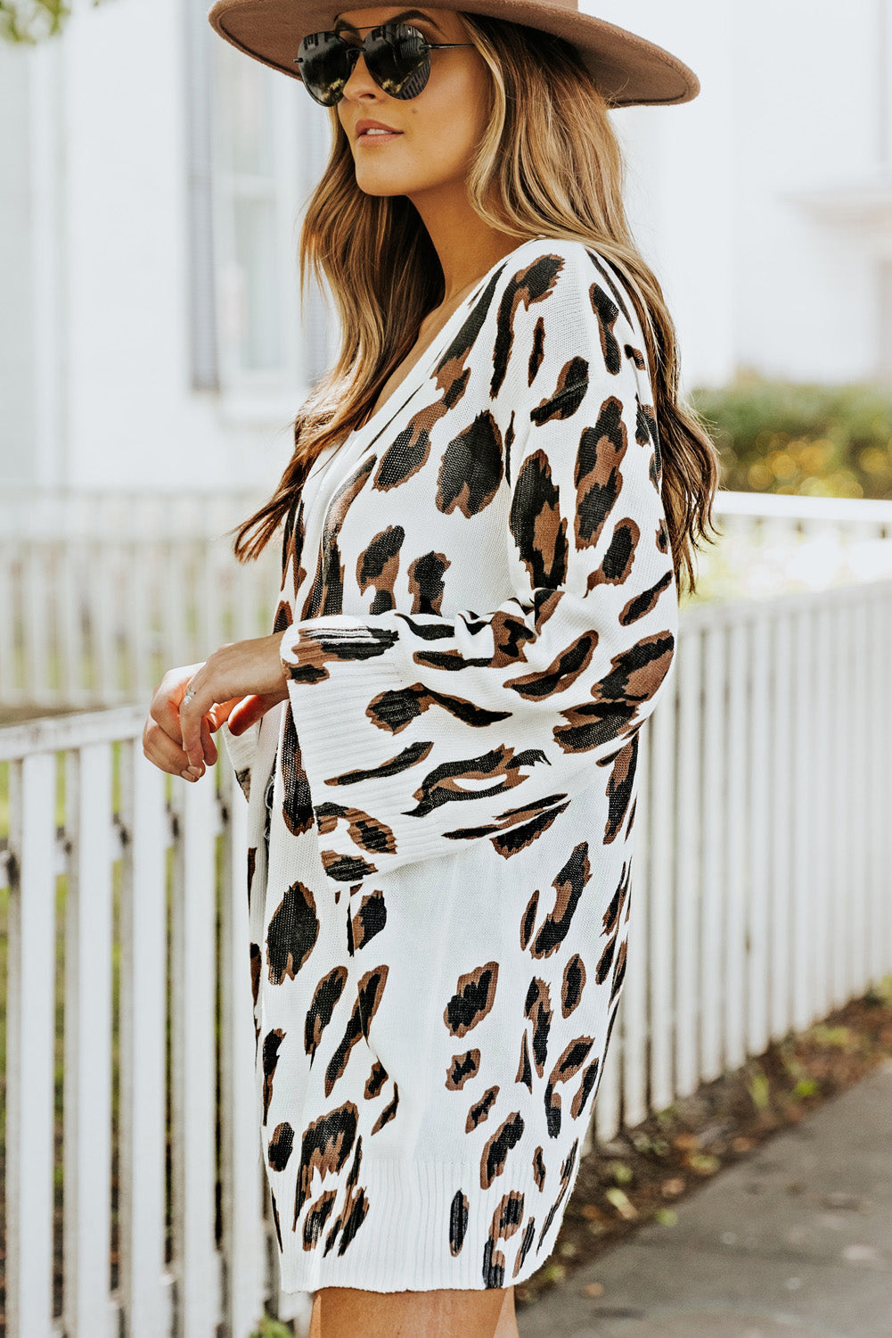 A stylish white cardigan featuring a leopard print design, bell sleeves, and an open front, perfect for autumn fashion.