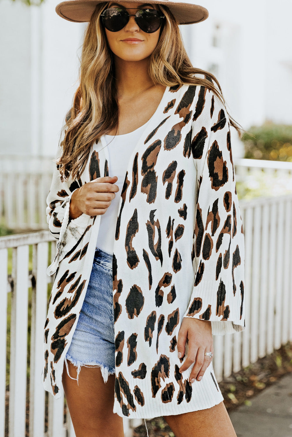 A stylish white cardigan featuring a leopard print design, bell sleeves, and an open front, perfect for autumn fashion.