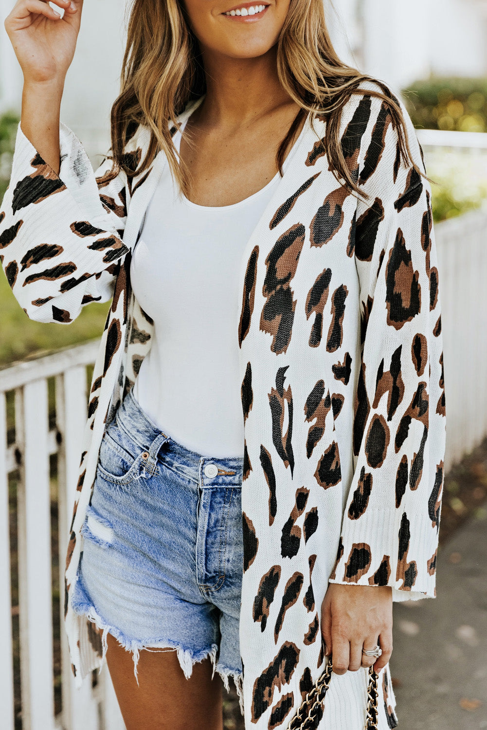 A stylish white cardigan featuring a leopard print design, bell sleeves, and an open front, perfect for autumn fashion.