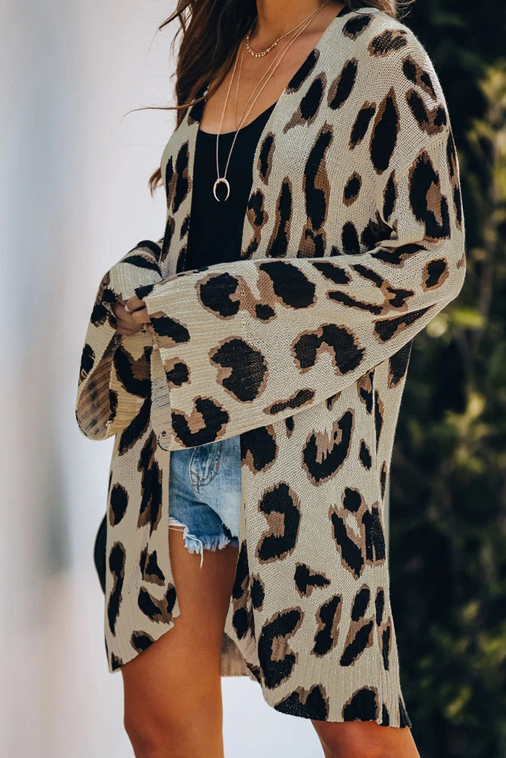 A stylish white cardigan featuring a leopard print design, bell sleeves, and an open front, perfect for autumn fashion.