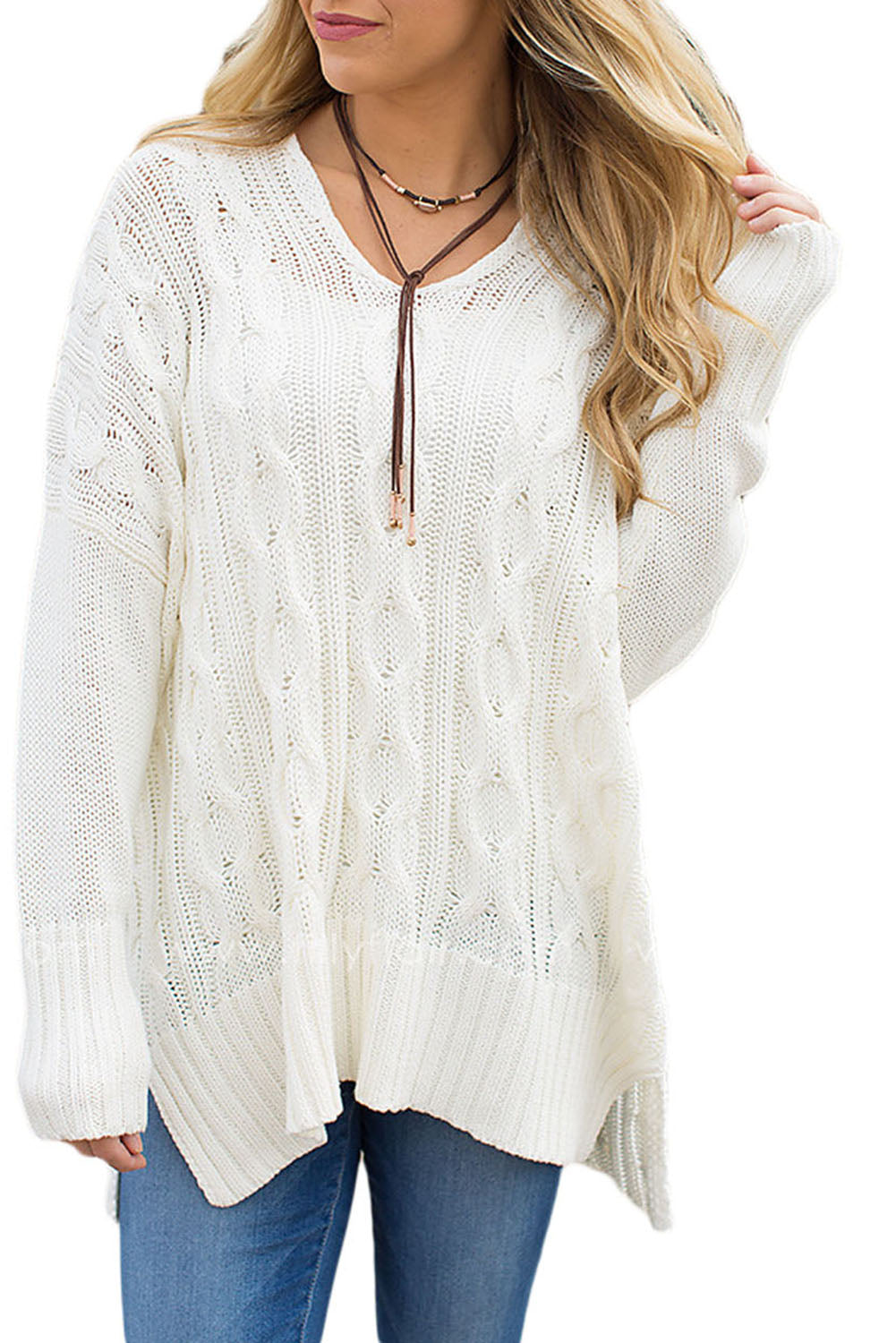 A stylish white oversized knit sweater with a deep v-neck and side slits, perfect for cozy wear.