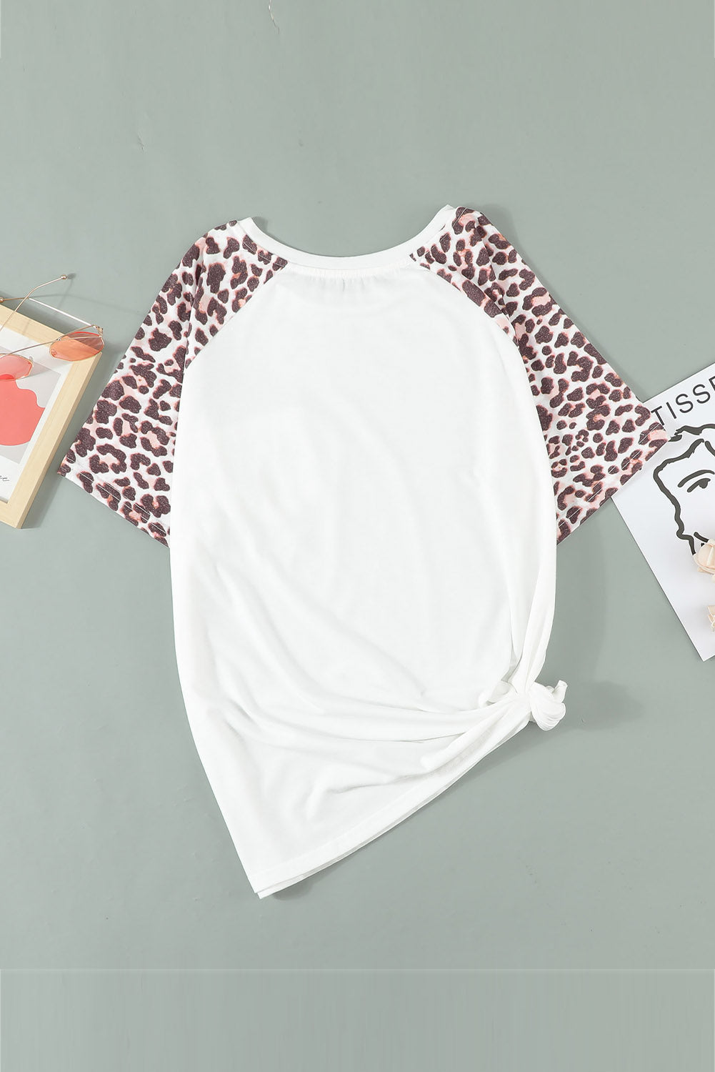 White plus size double pocket top featuring a chic leopard print and color block design, perfect for casual wear.