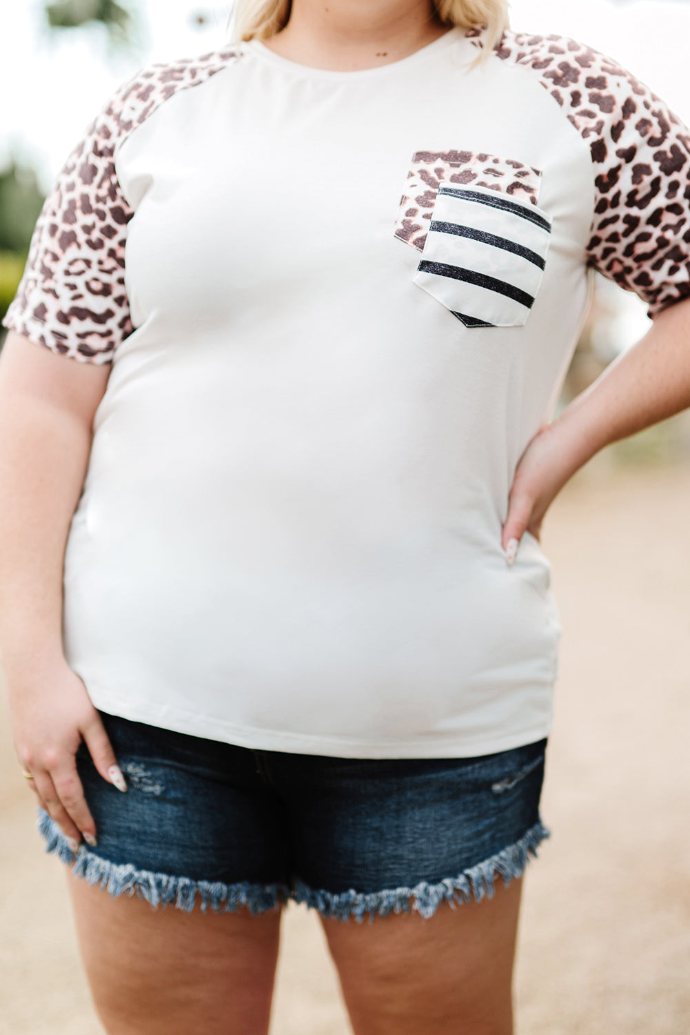 White plus size double pocket top featuring a chic leopard print and color block design, perfect for casual wear.