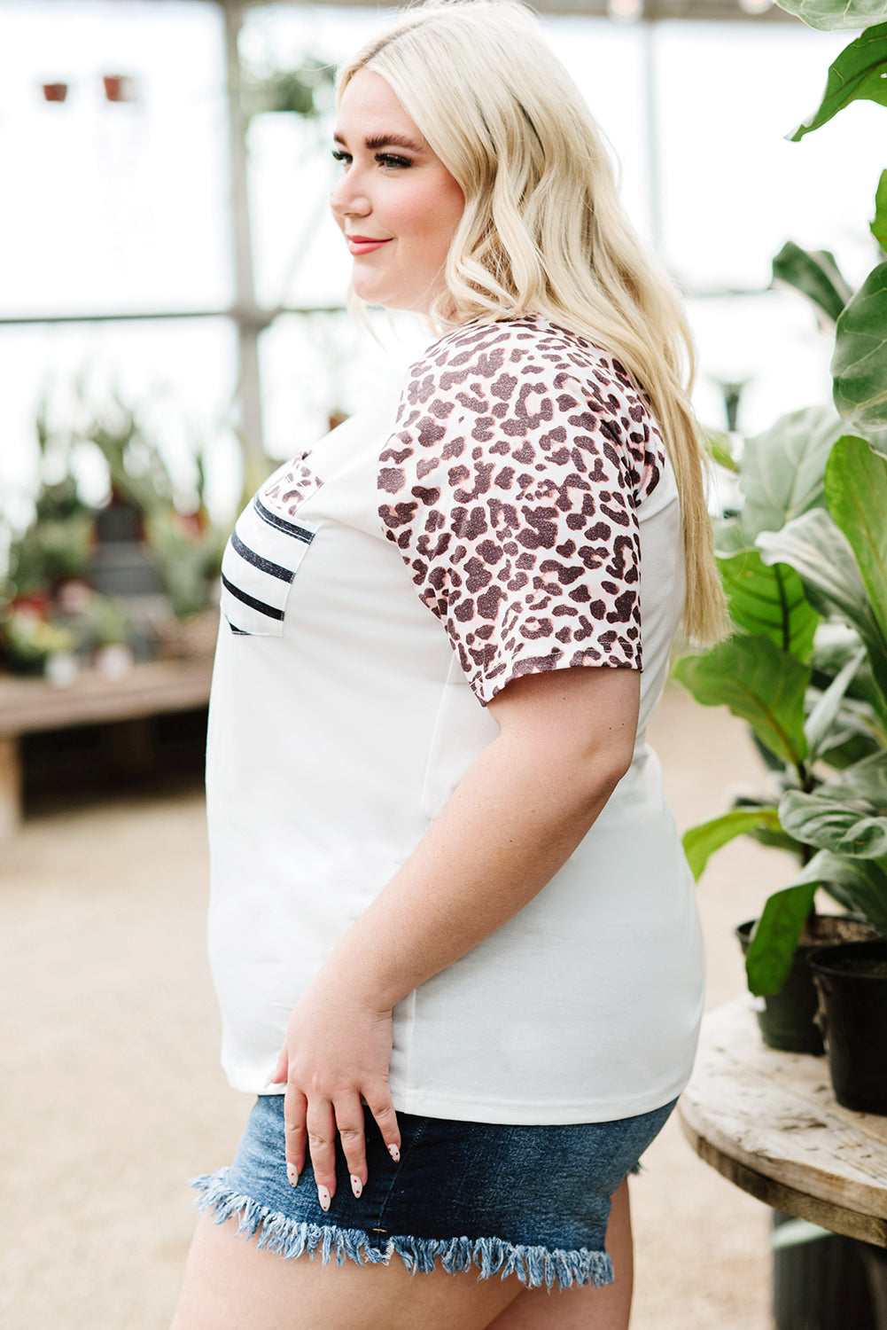 White plus size double pocket top featuring a chic leopard print and color block design, perfect for casual wear.