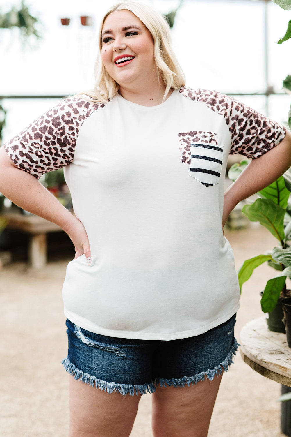 White plus size double pocket top featuring a chic leopard print and color block design, perfect for casual wear.